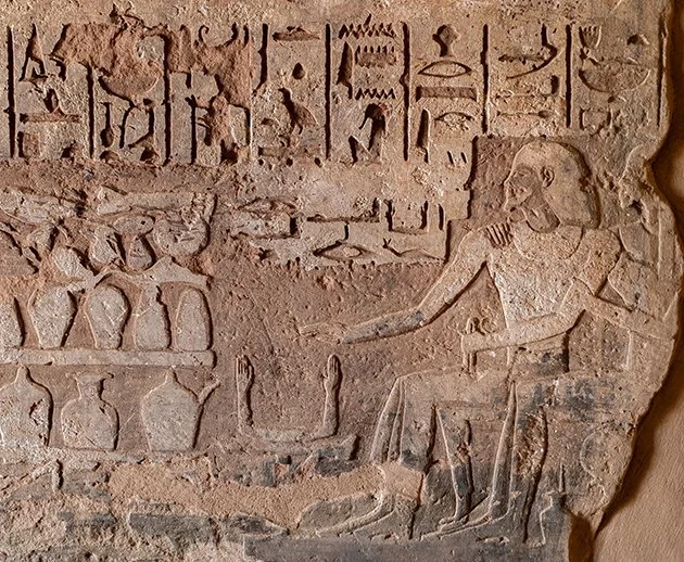 Carved relief image from the tomb of Ahmose, son of Ibana showing the deceased before offerings.