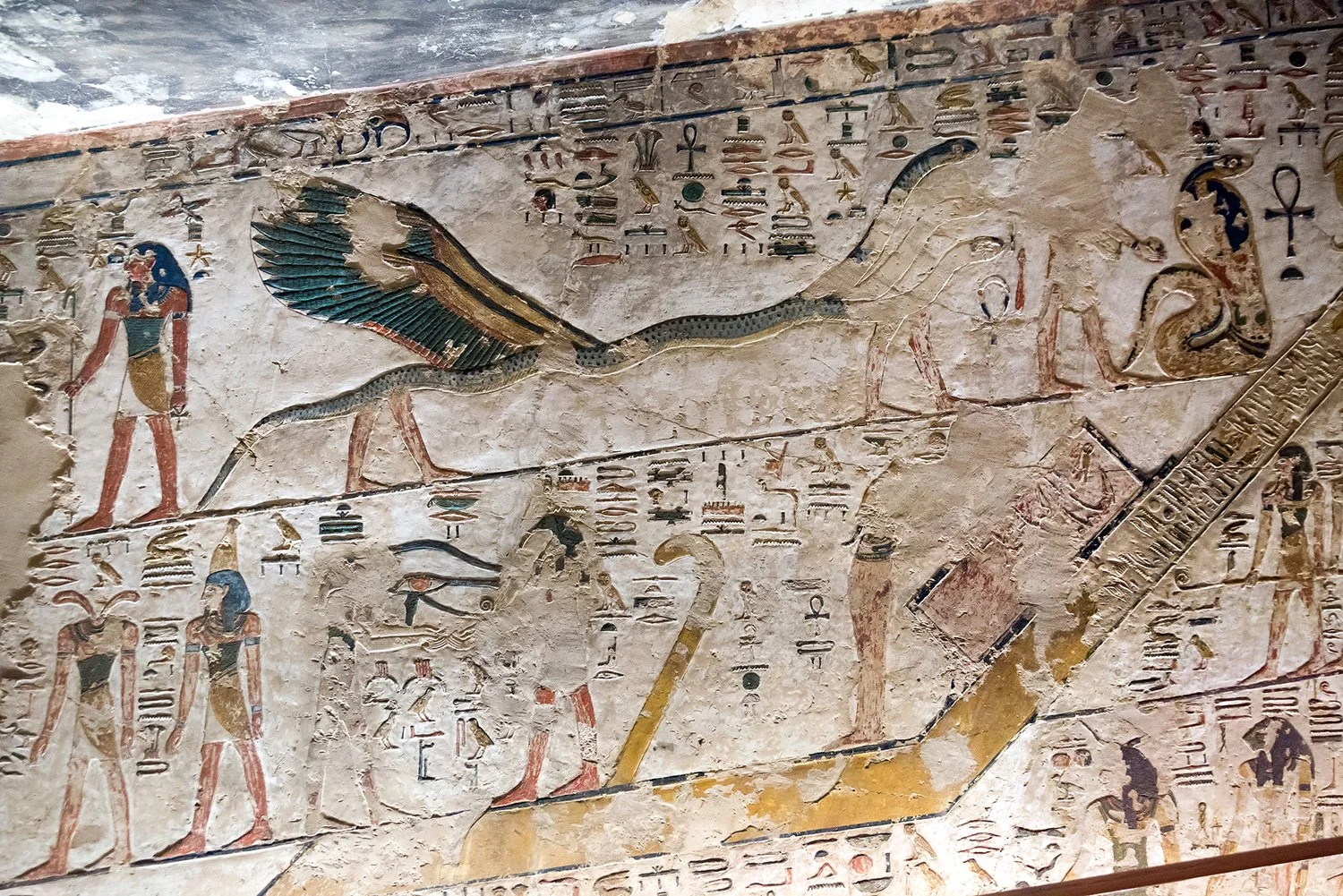 Ancient Egyptian painted relief of a winged three-headed serpent and other deities.