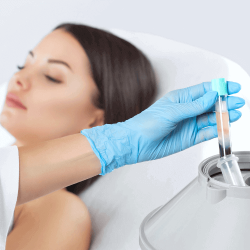 A woman receiving a medical injection or IV treatment, with a healthcare professional wearing blue gloves.