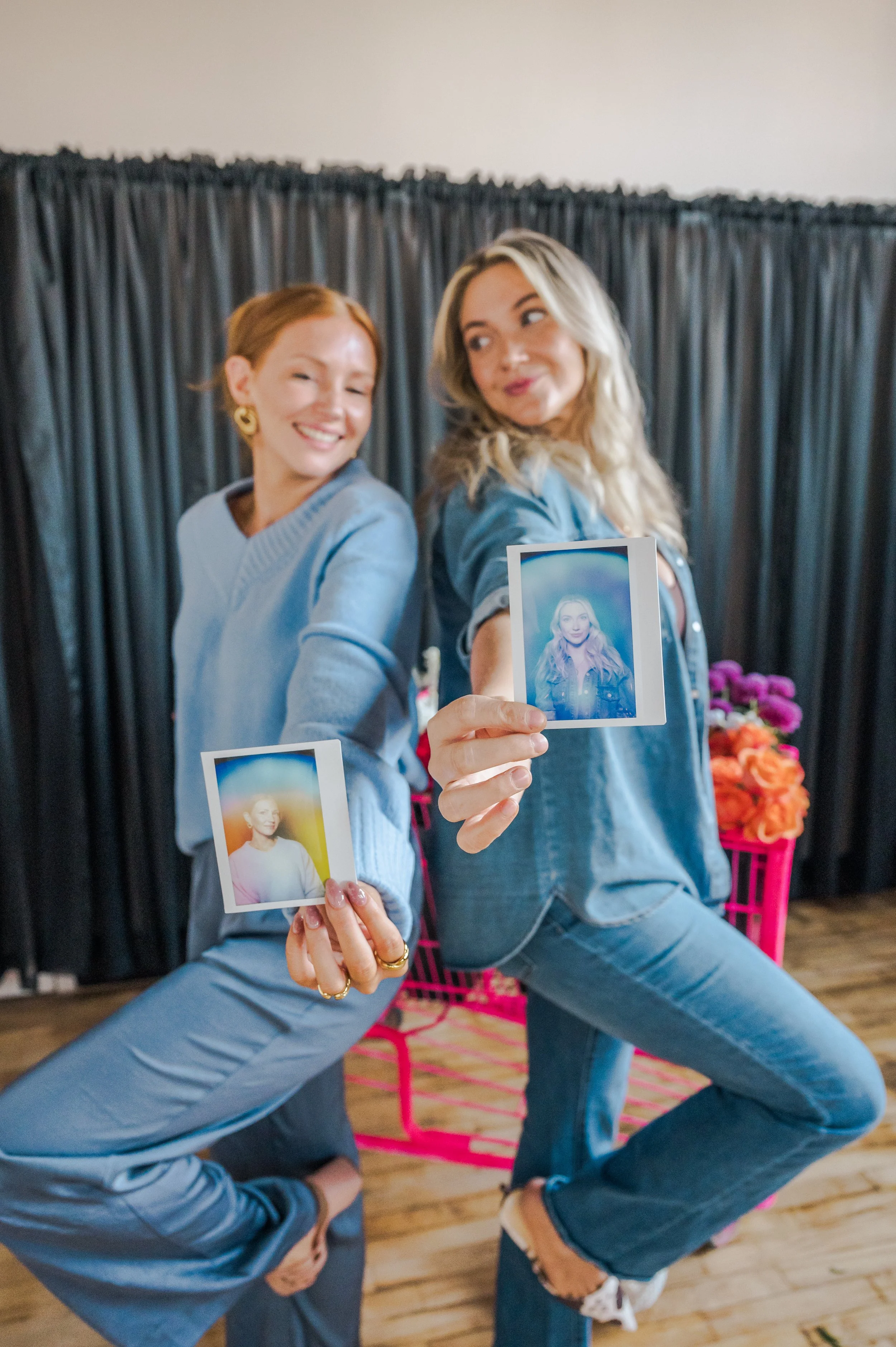 two girls at a wellneses event holding their aura photos in Washington DC