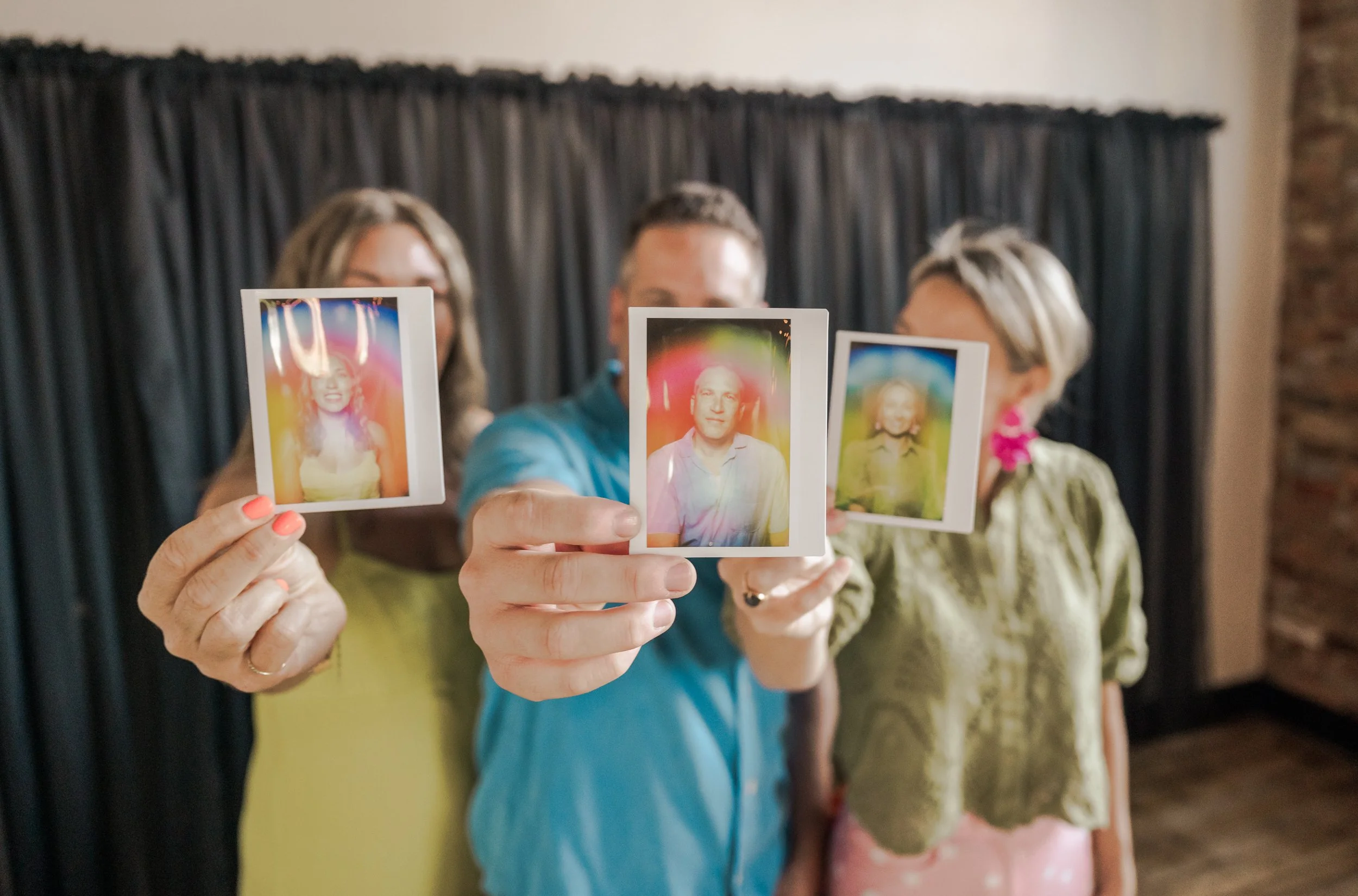 coporate wellness event three colleages holding aura photos