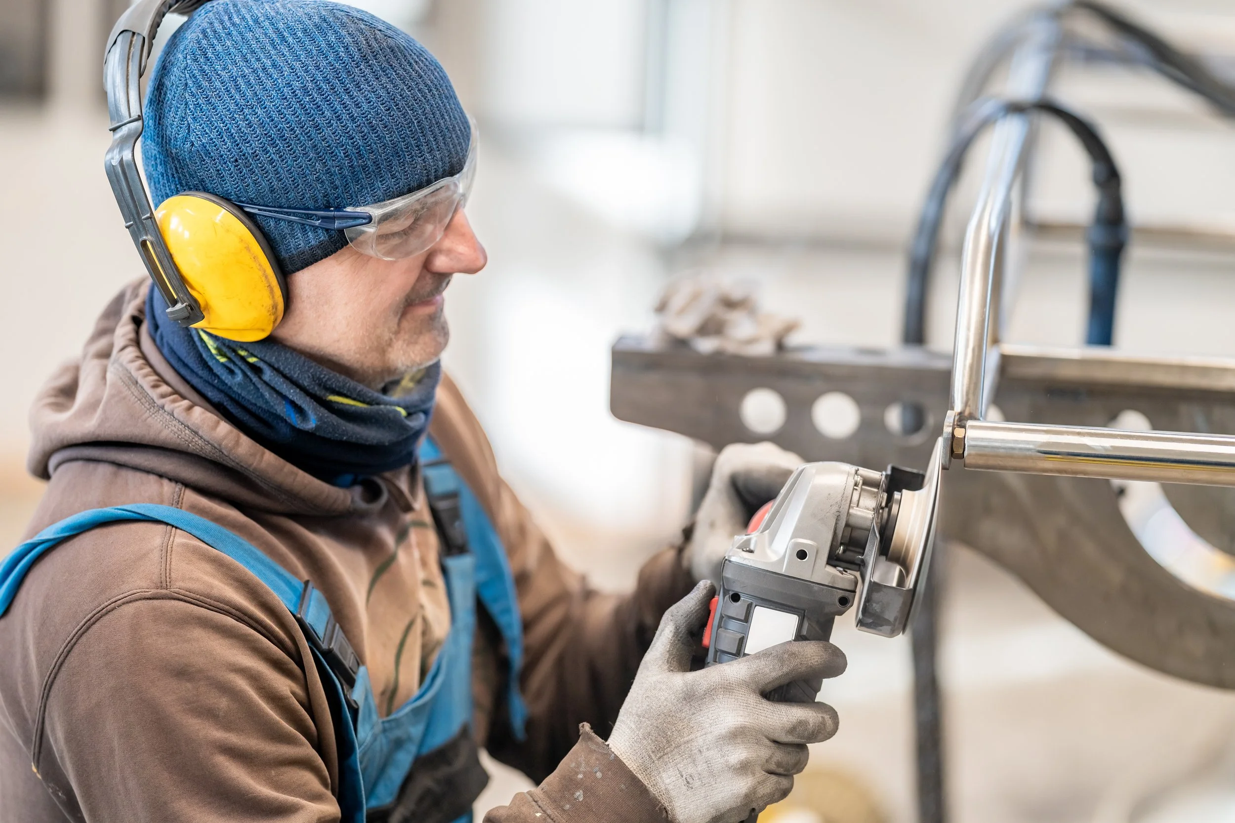 an-engineer-in-work-clothes-grinds-stainless-steel-2025-01-08-03-36-03-utc.jpg