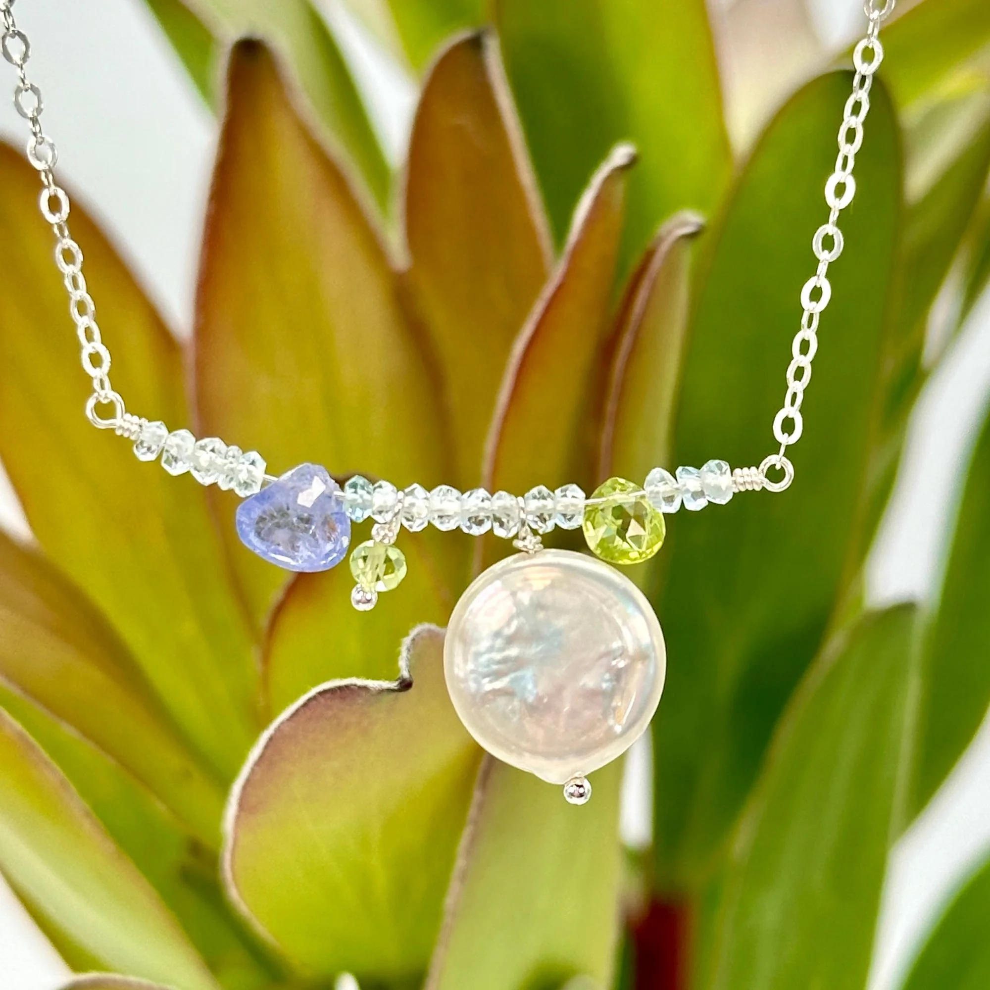 9:7 Branch blue topaz coin peridot tanzanite close up.jpg