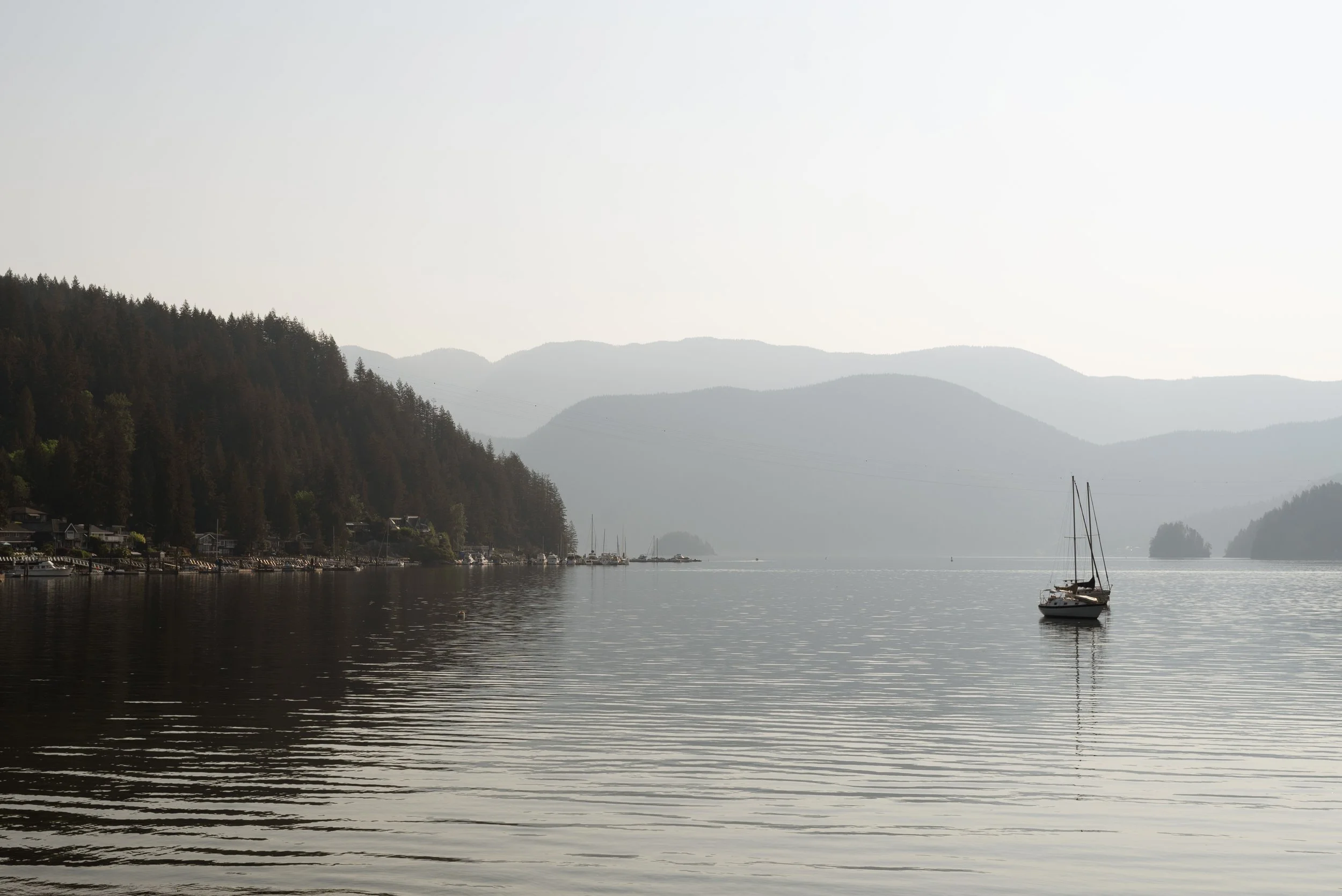 08-deep-cove-bc-sailboat-calm-water-mountain-haze.jpg