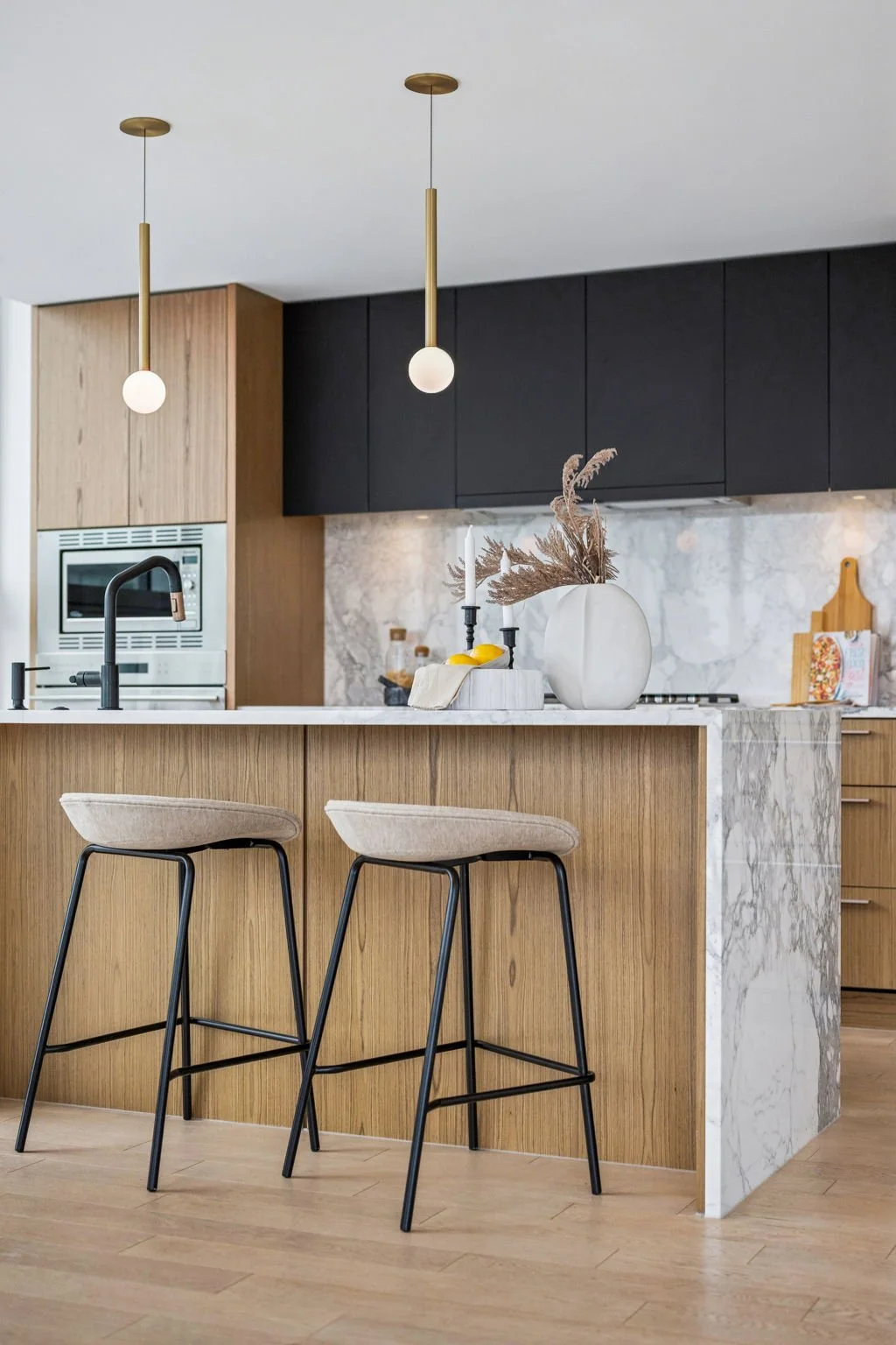 yaletown-home-kitchen-marble-island-oak-cabinets-gold-pendants.jpg