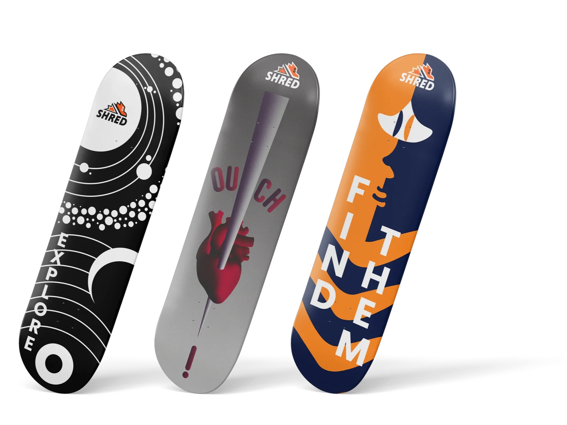 Three skateboard decks with different designs leaning against each other. The first deck is black and white with planetary and cosmic patterns. The second deck is gray with an anatomical heart illustration and the phrase 'OUCH' in red. The third deck is blue and orange with abstract shapes and text that spells 'FIND THEM'.