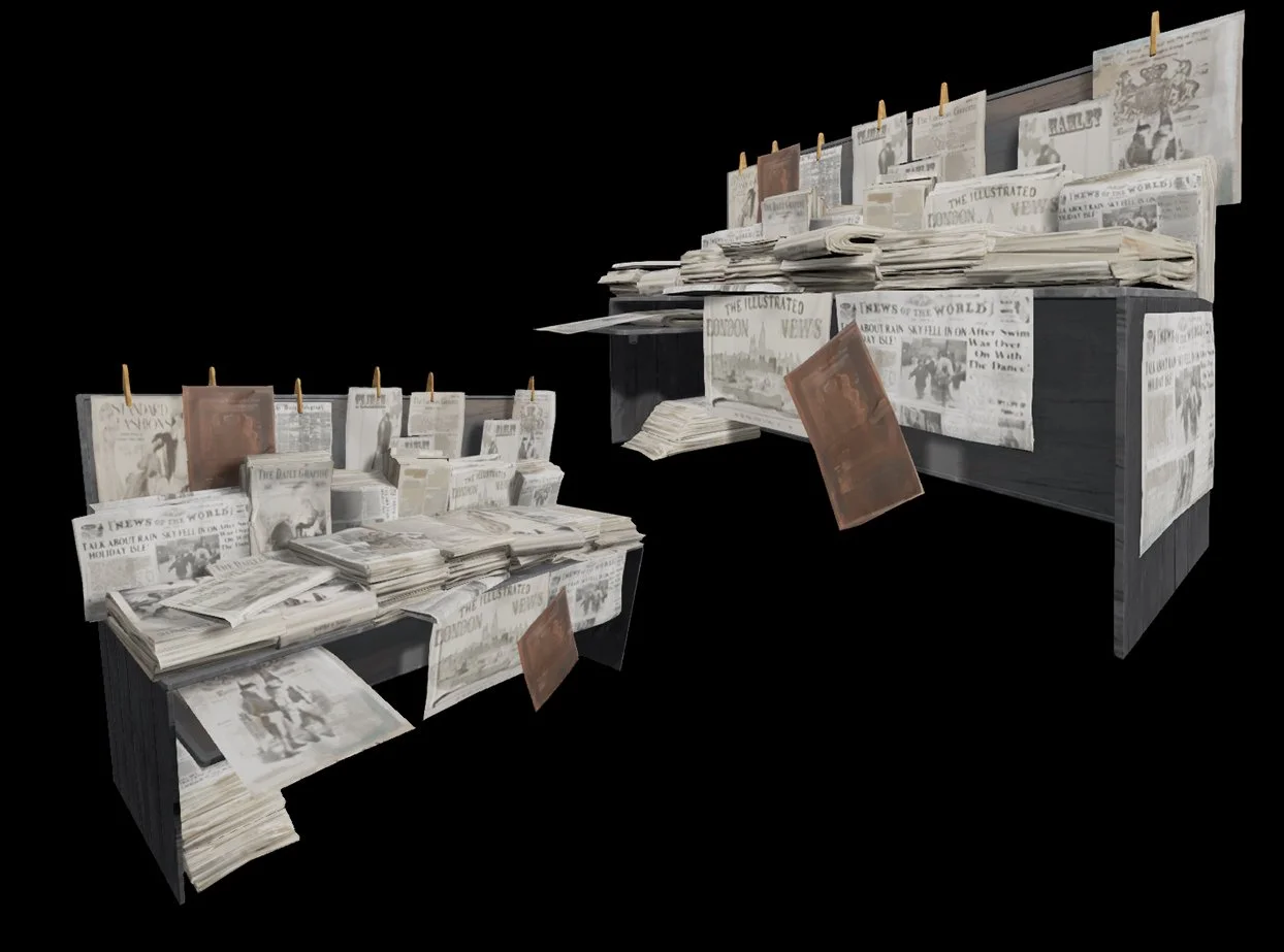 Displays two tables covered with newspapers, magazines, and papers, some hanging on clothespins, with a black background.