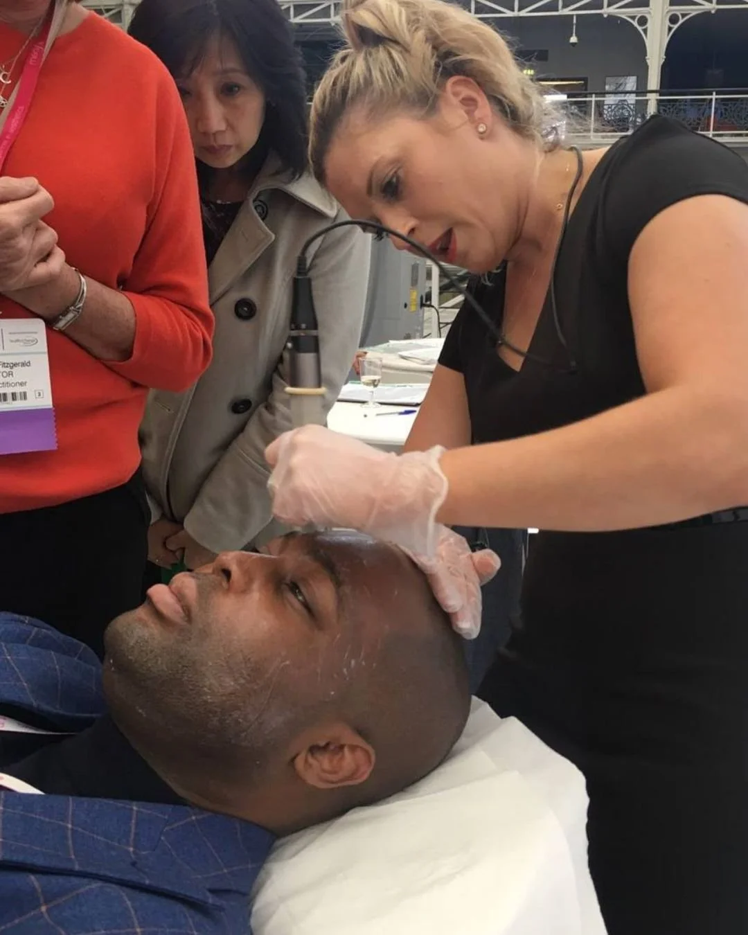 Jody Adele Taylor demonstrates microneedling live at a trade show in Earls Court.