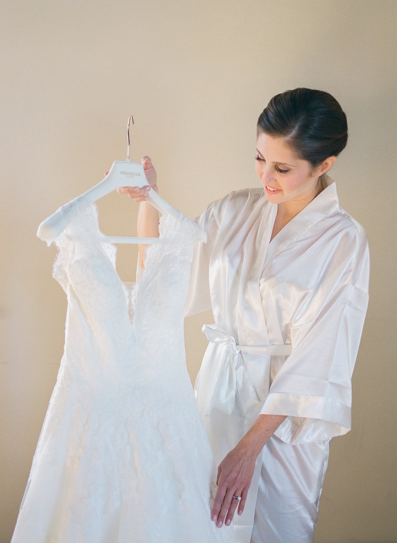 Bride admiring wedding gown