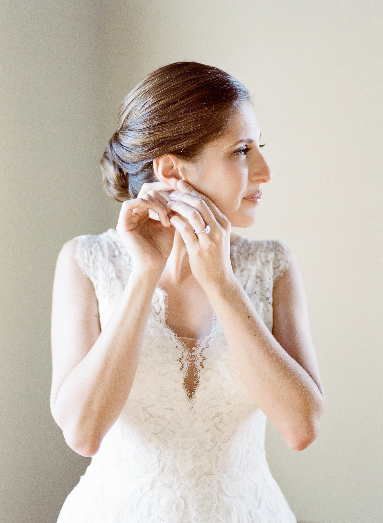 Bride putting in earrings 