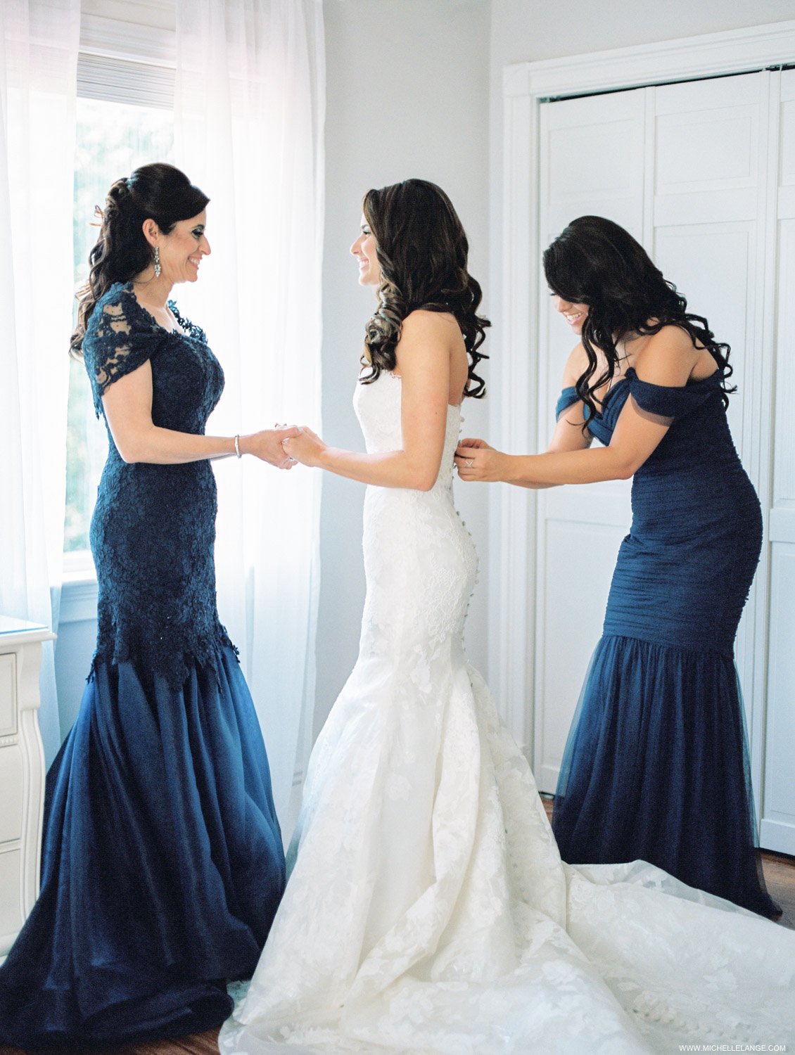 Bride with mom and maid of honor getting ready