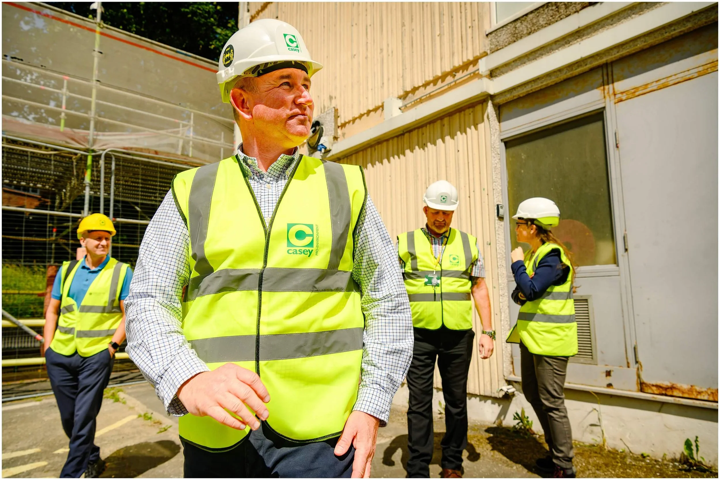 Construction workers in hard hats and high-visibility vests at an industrial site