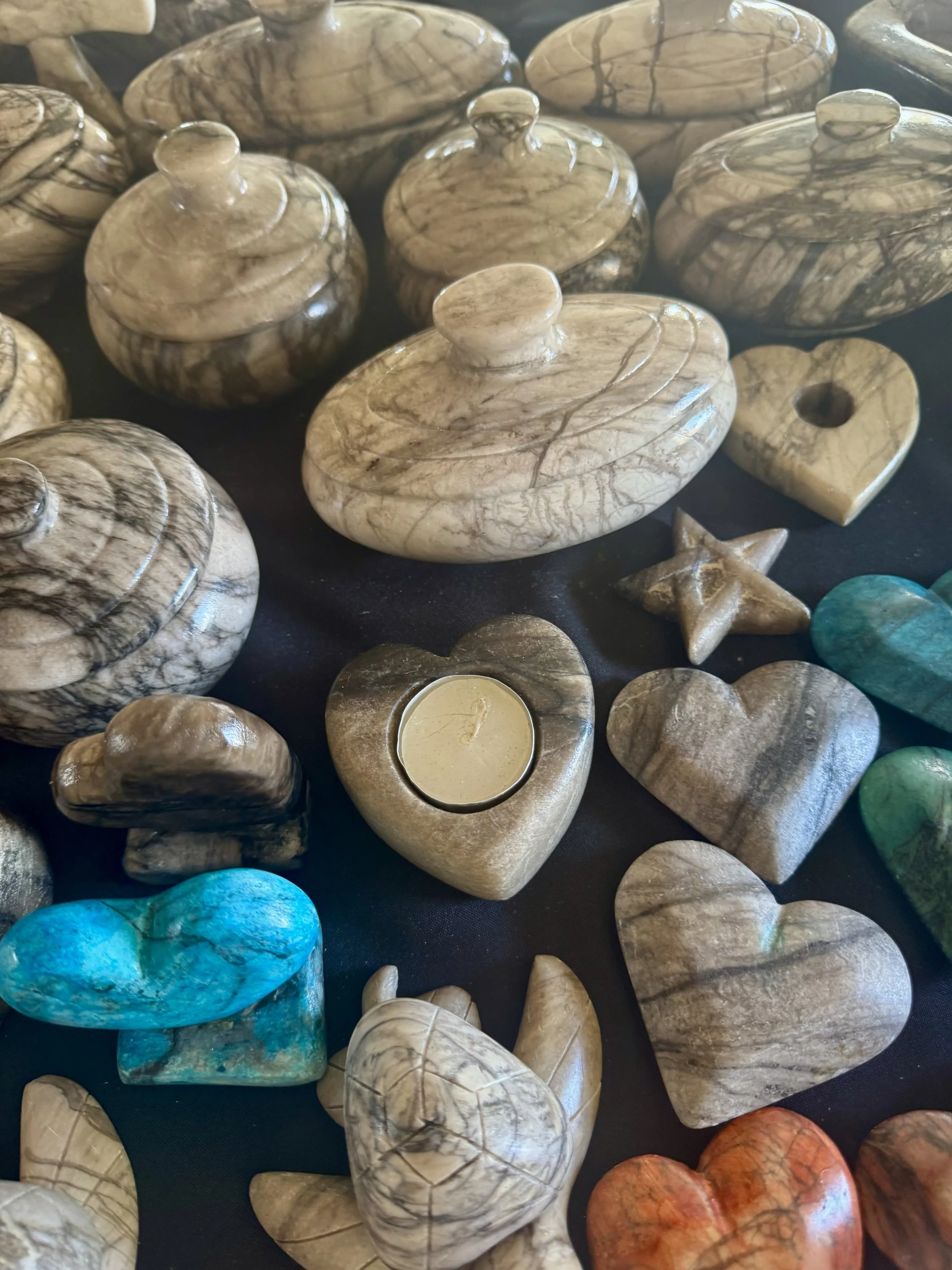 Hand-carved stone hearts and decorative keepsakes in Falmouth, Jamaica market.