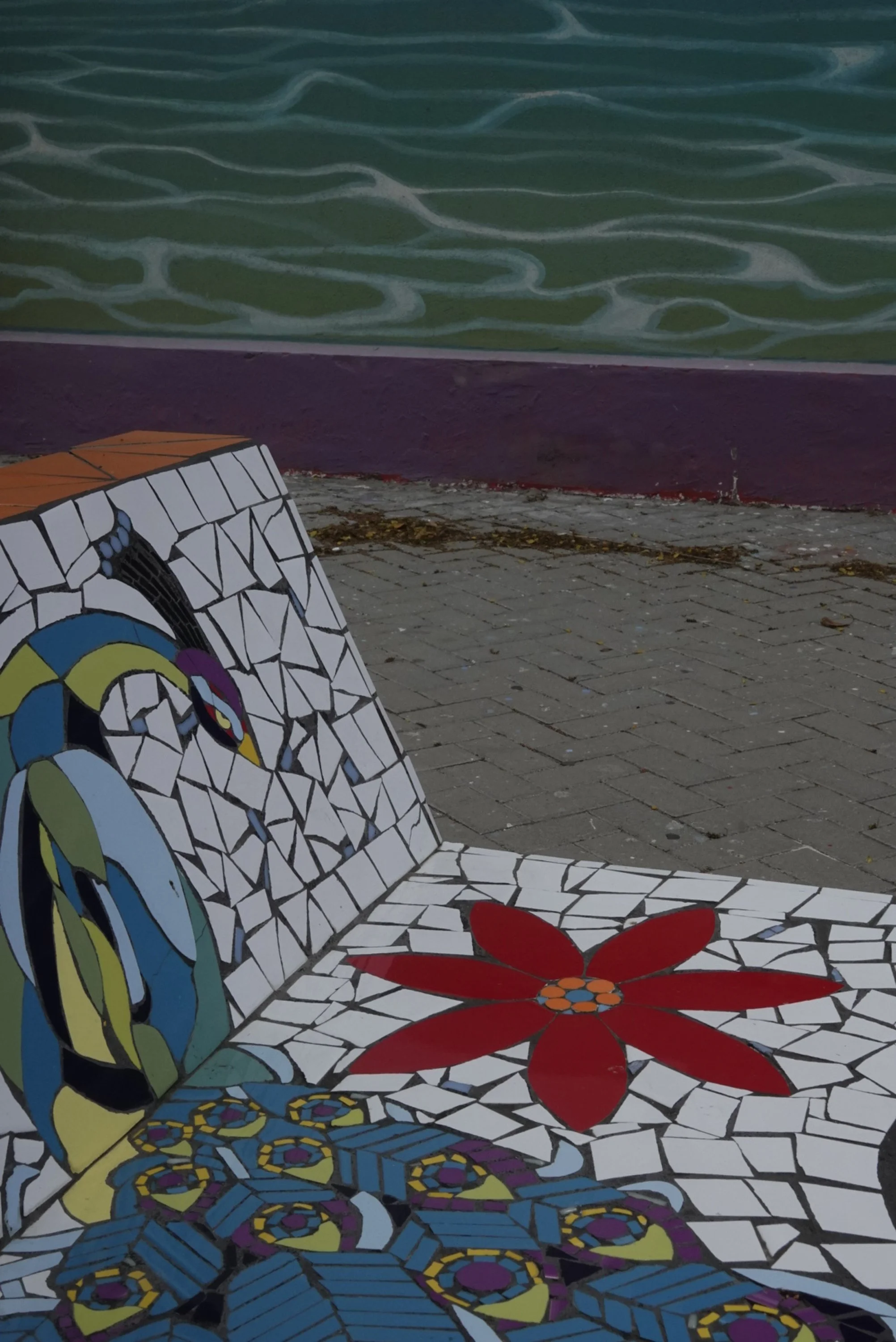Colorful mosaic bench with bird design in Curaçao public art space