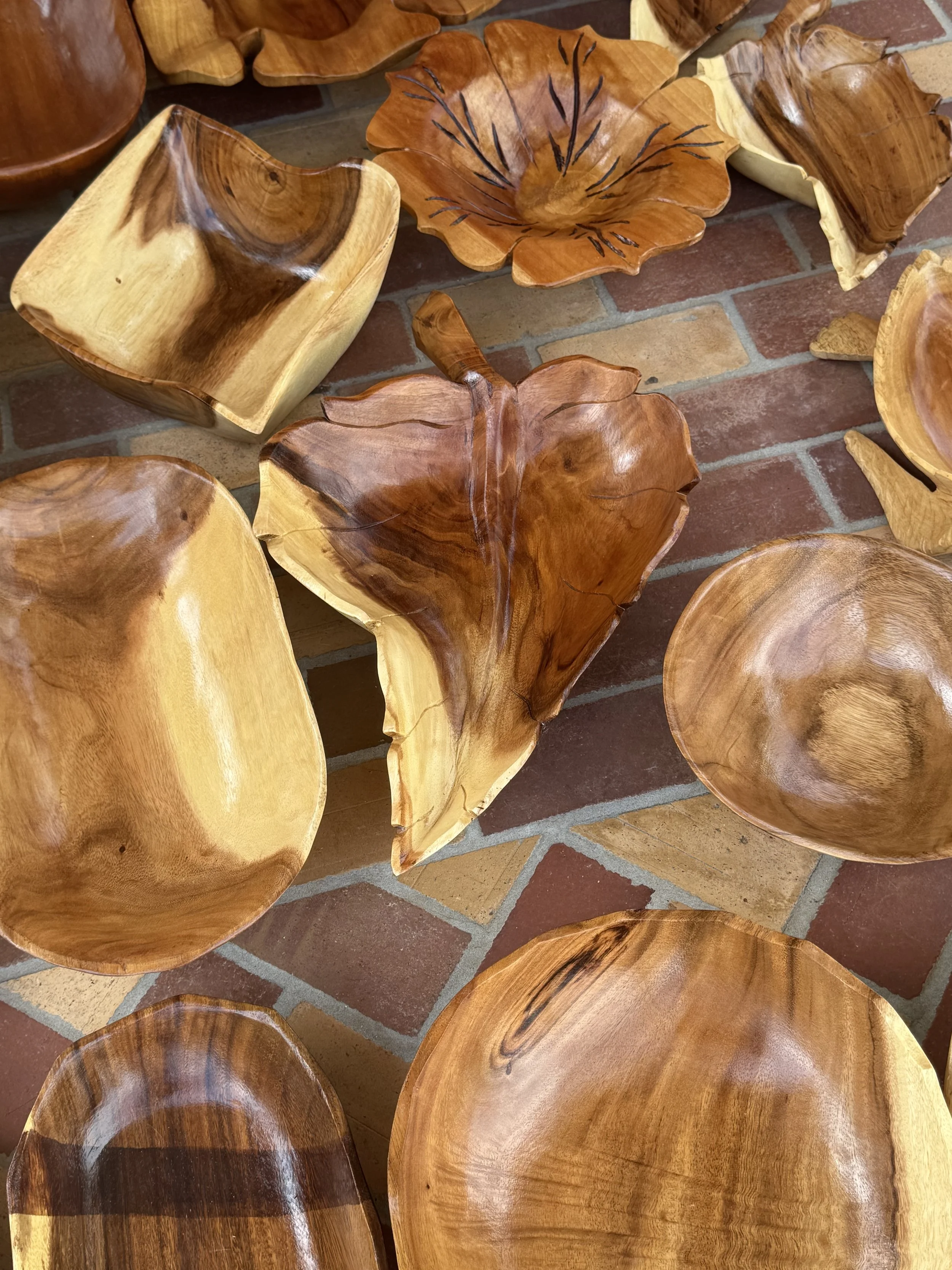 Handcrafted wooden bowls and carved serving pieces in Falmouth, Jamaica market.