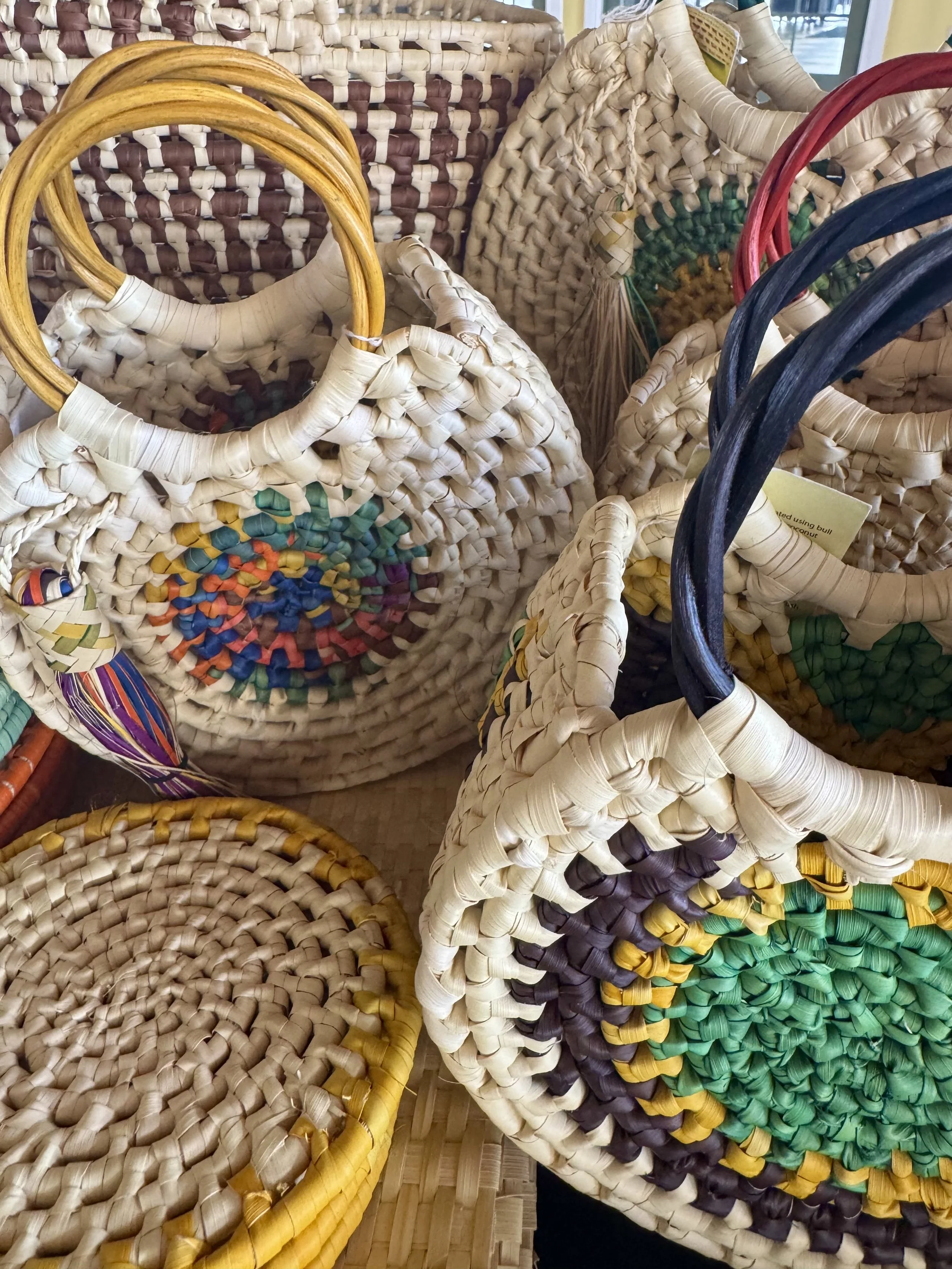 Woven straw handbags and baskets in Falmouth, Jamaica craft market.