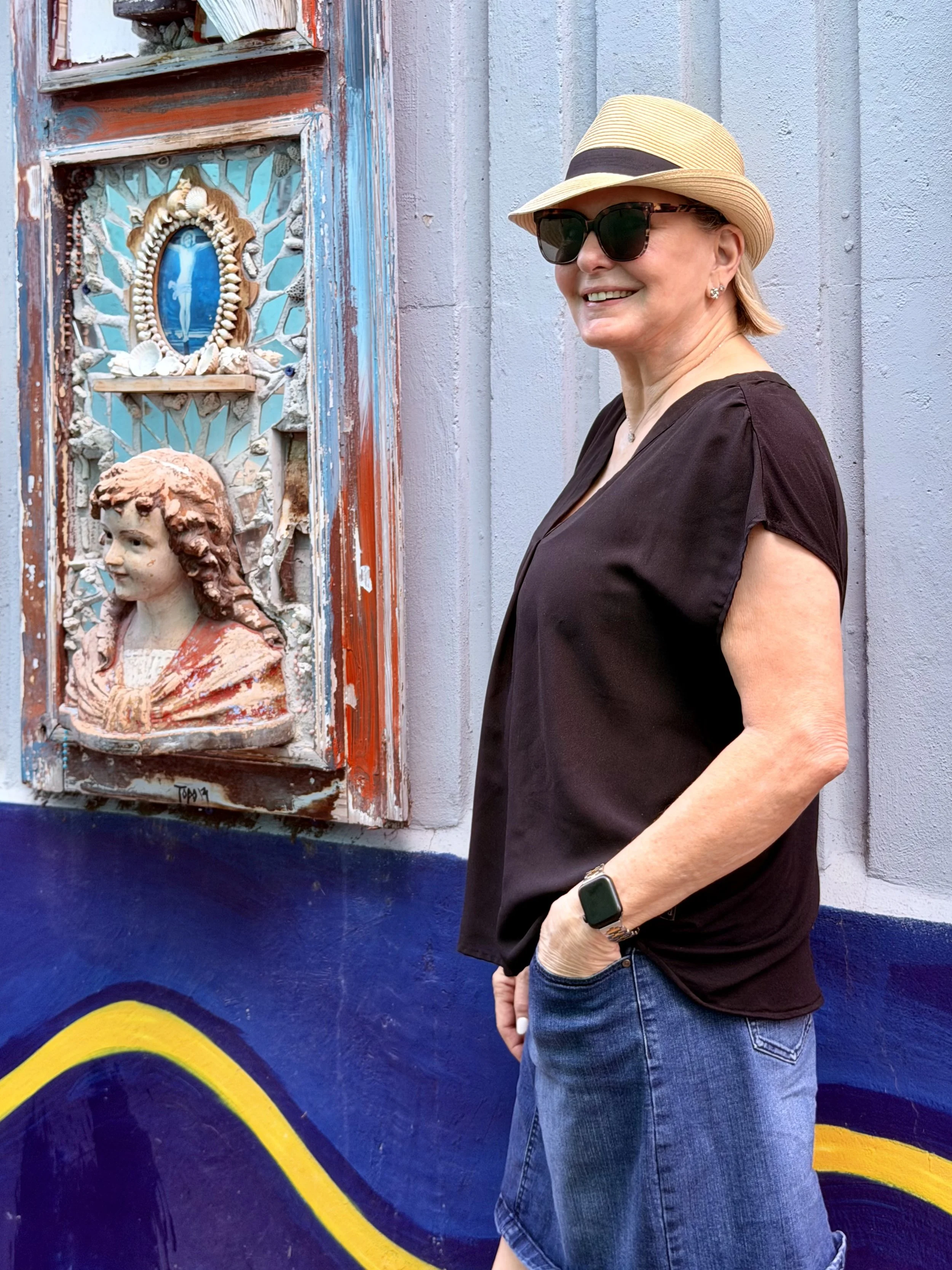 Traveler standing by colorful street art.