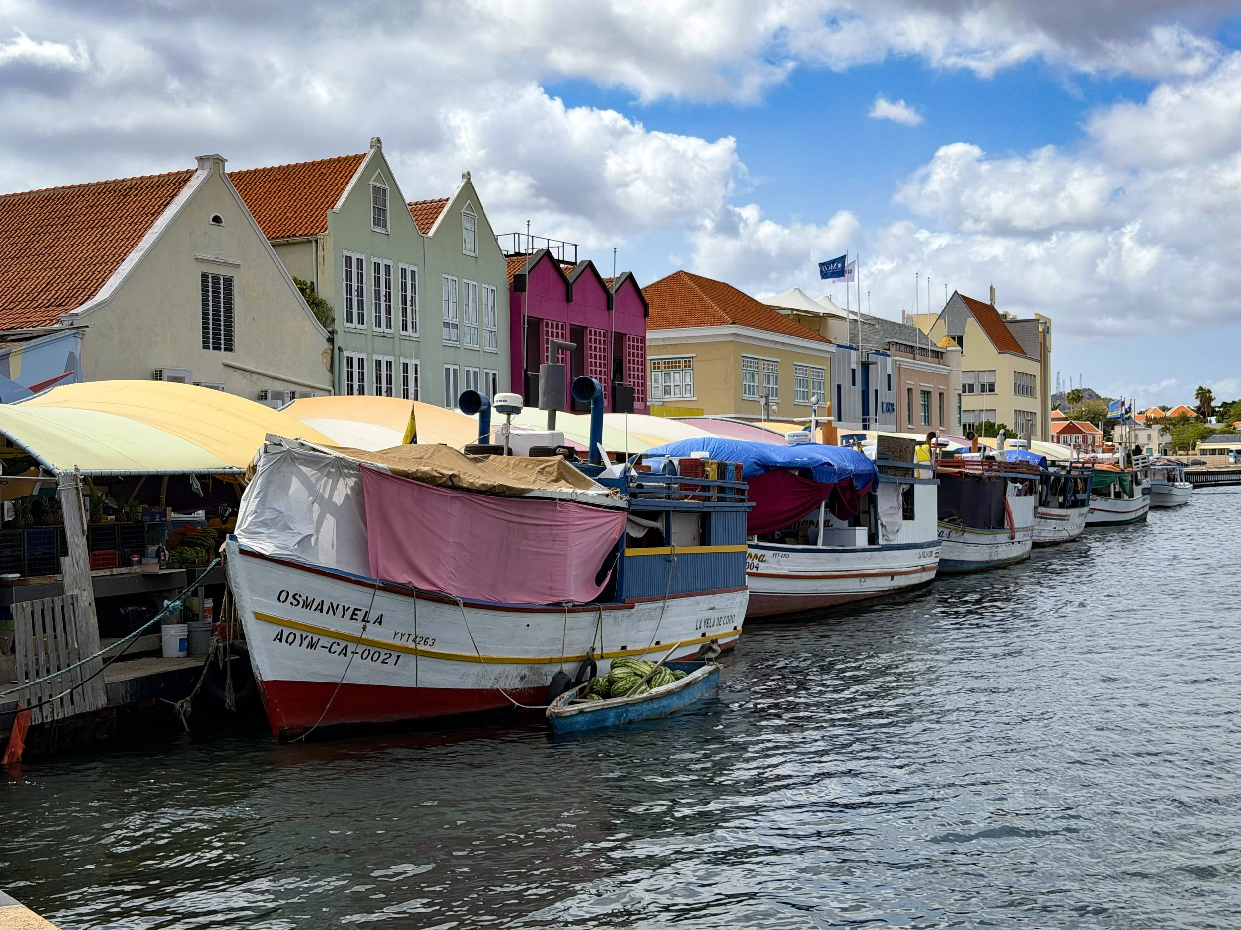 Colorful Willemstad waterfront with boats and pastel buildings in Curaçao