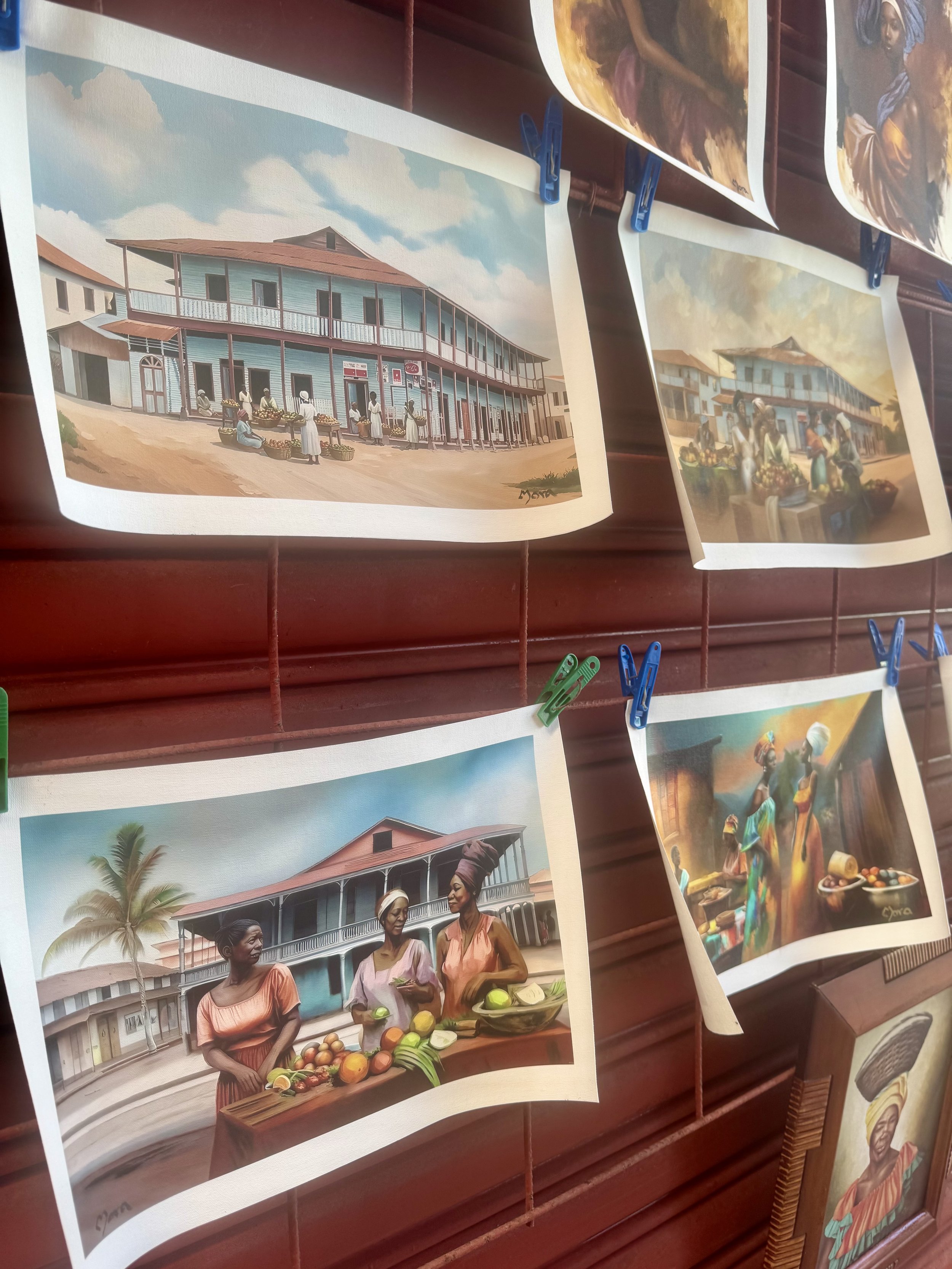 Local paintings and artwork displayed in Limon, Costa Rica market.