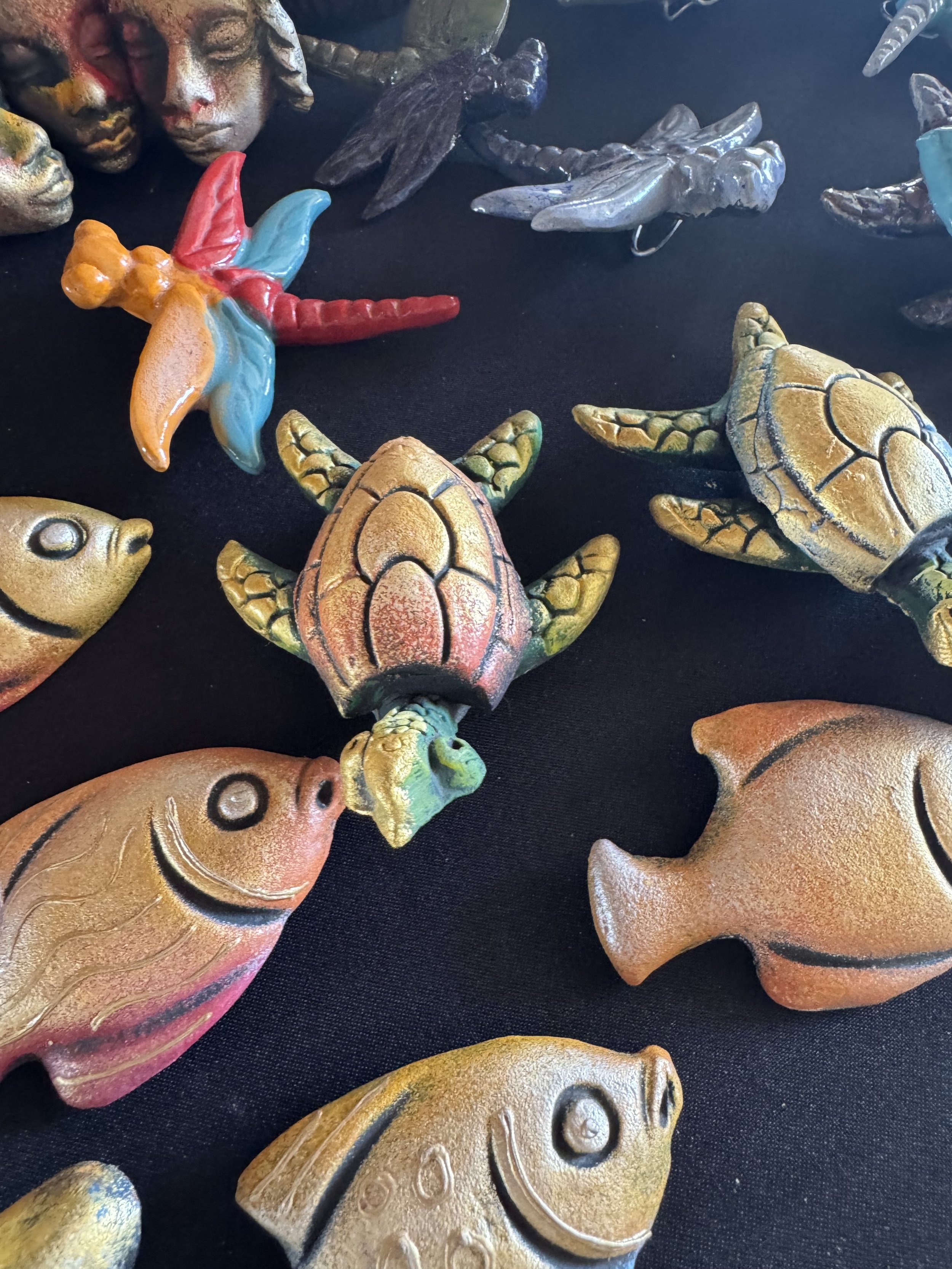 Hand-painted wooden fish and sea life crafts in Falmouth, Jamaica market.
