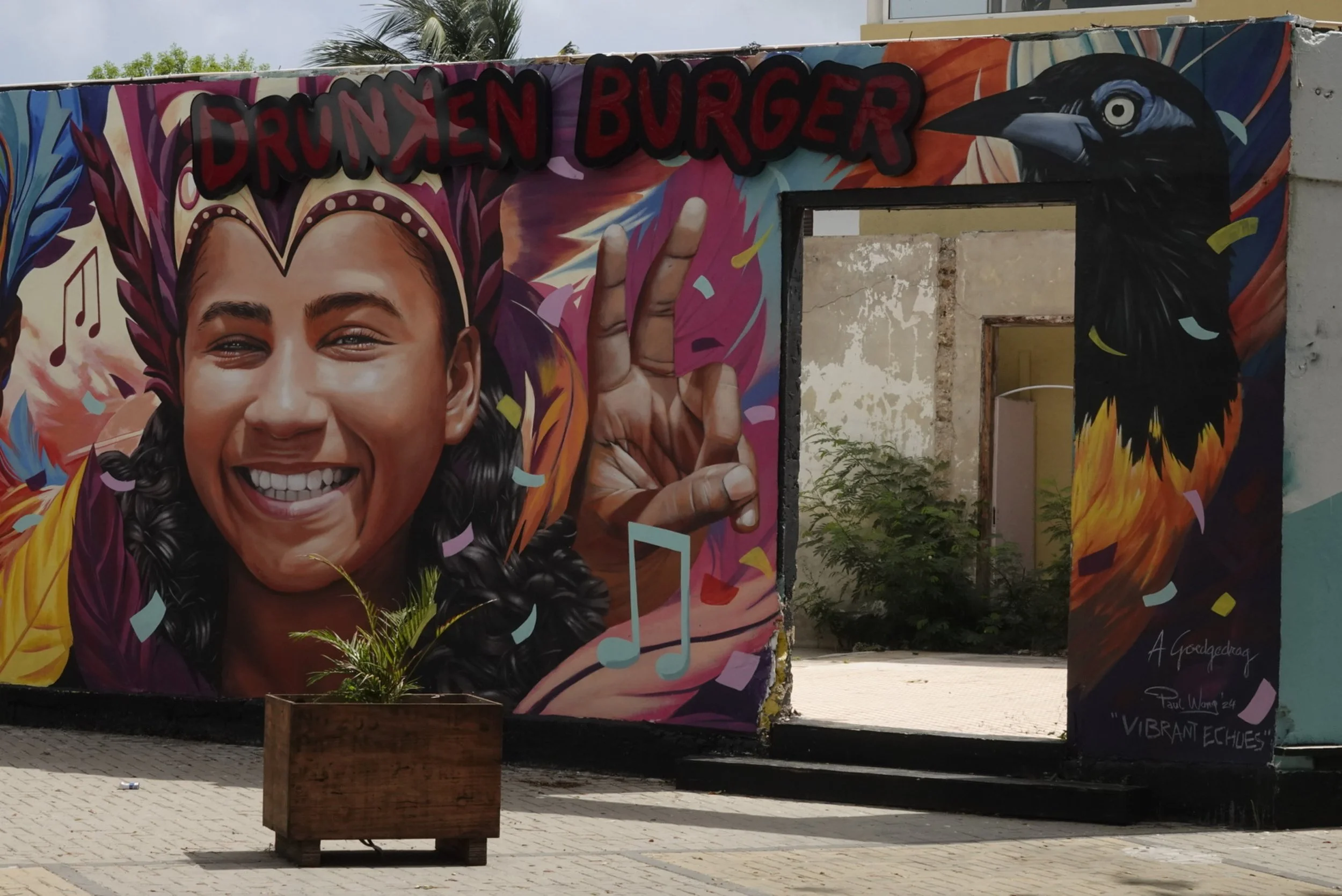 Festival themed mural reading Drunken Burger in Curaçao street art area