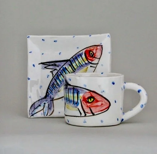 Mug and plate with a fish design.