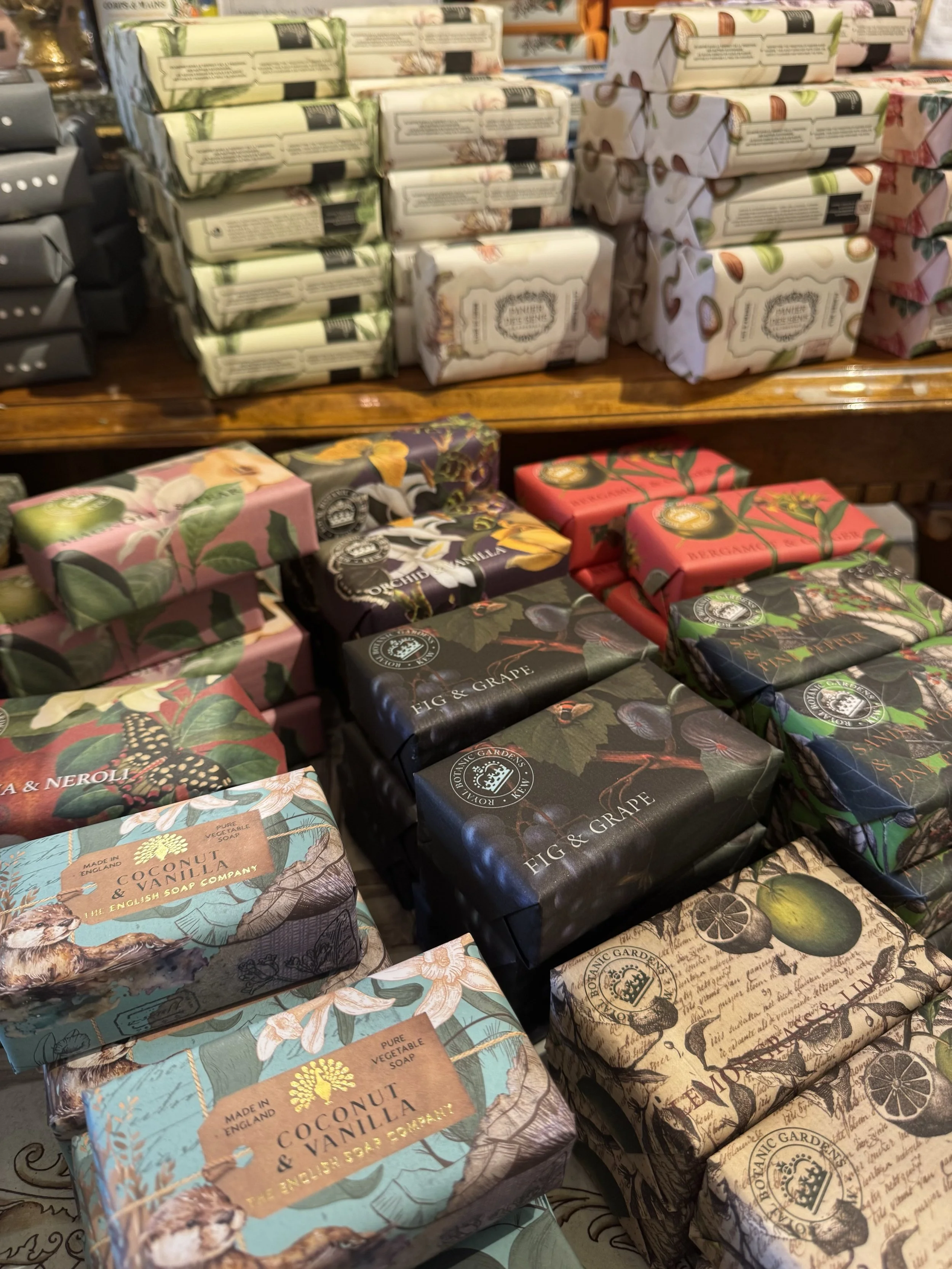 Artisan bar soaps in decorative packaging displayed at specialty gift shop