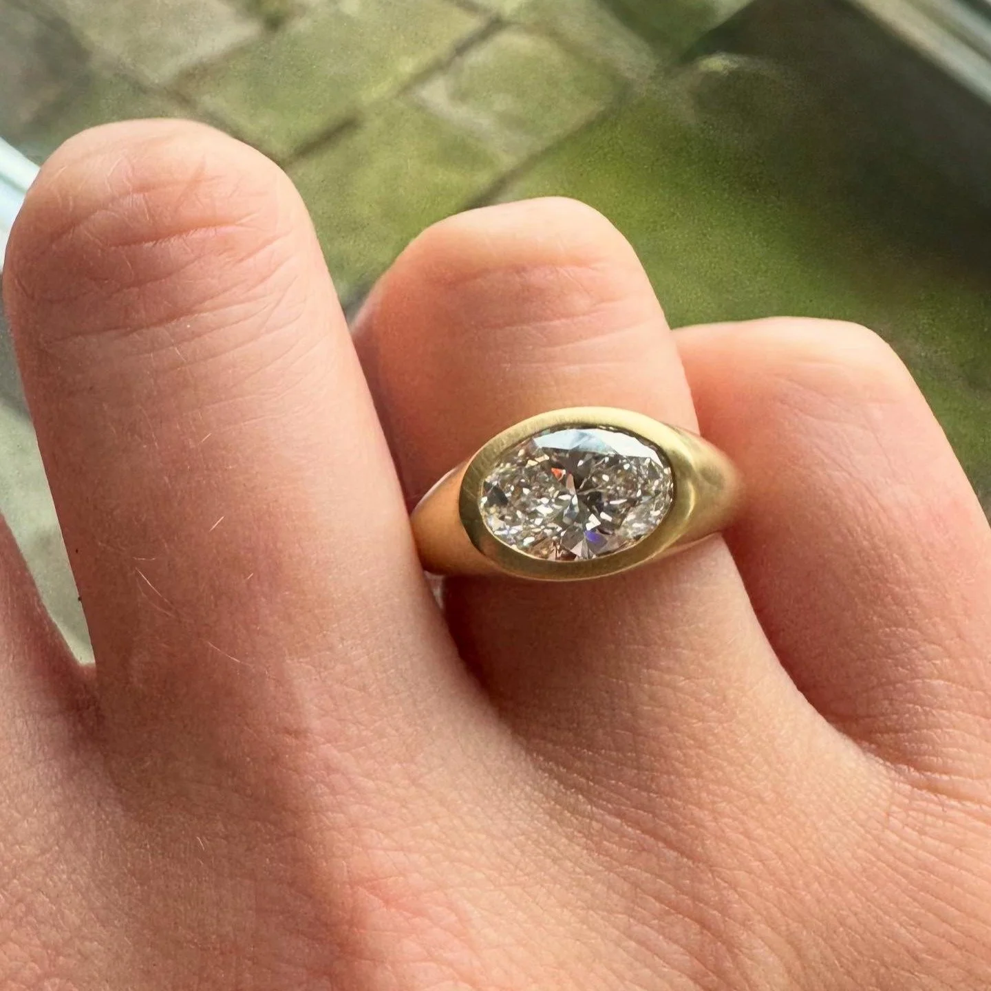 Loved working on this commission. 

An oval cut diamond set in a simple bezel, with a chunky gold band and soft brushed finish.

Drop me a message to commission your own.