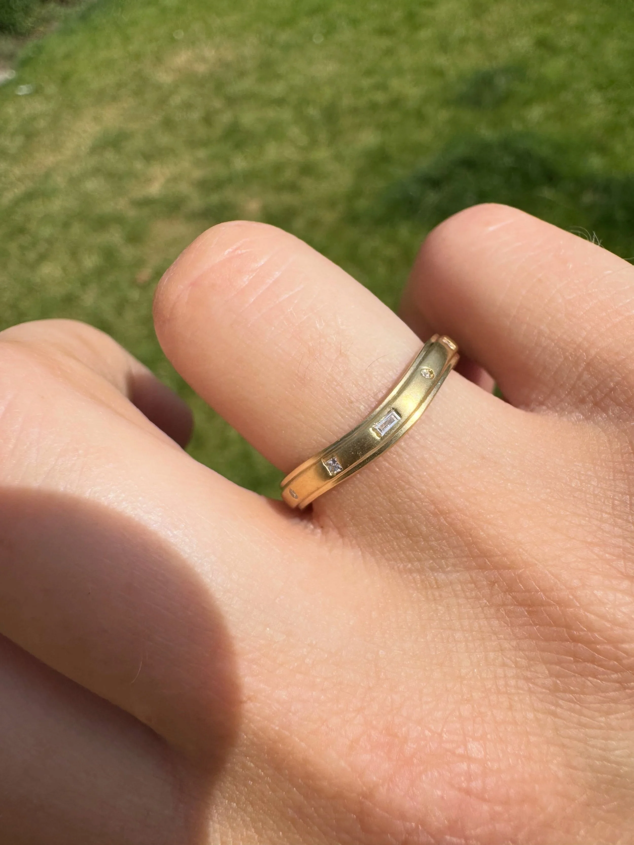 Wedding bands can be made to fit around your engagement ring.

We can add a slight curve to the band so it sits neatly alongside your ring, and add diamonds or gemstones in different cuts and settings to make it your own.