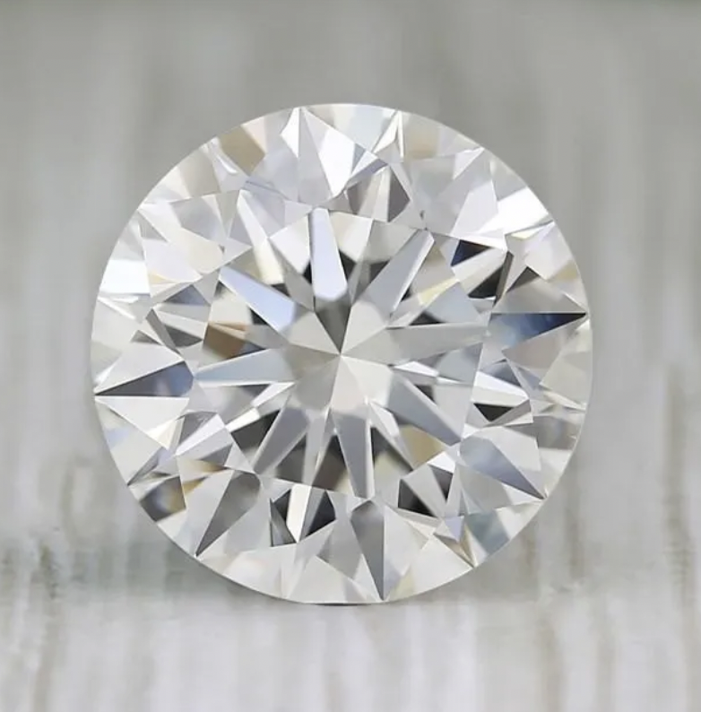 A close-up of a round-cut diamond with precise faceting and brilliance.