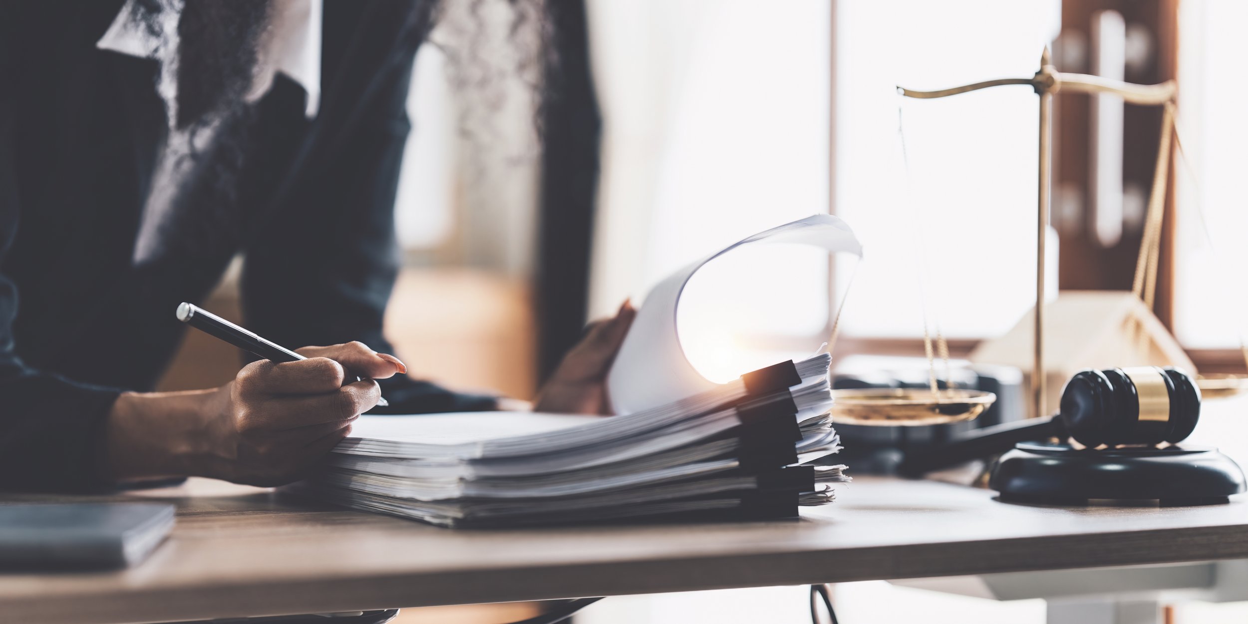 Lawyer-business-woman-working-or-reading-lawbook-in-office-workplace-for-consultant-lawyer-concept-1425131504_4467x2234.jpeg