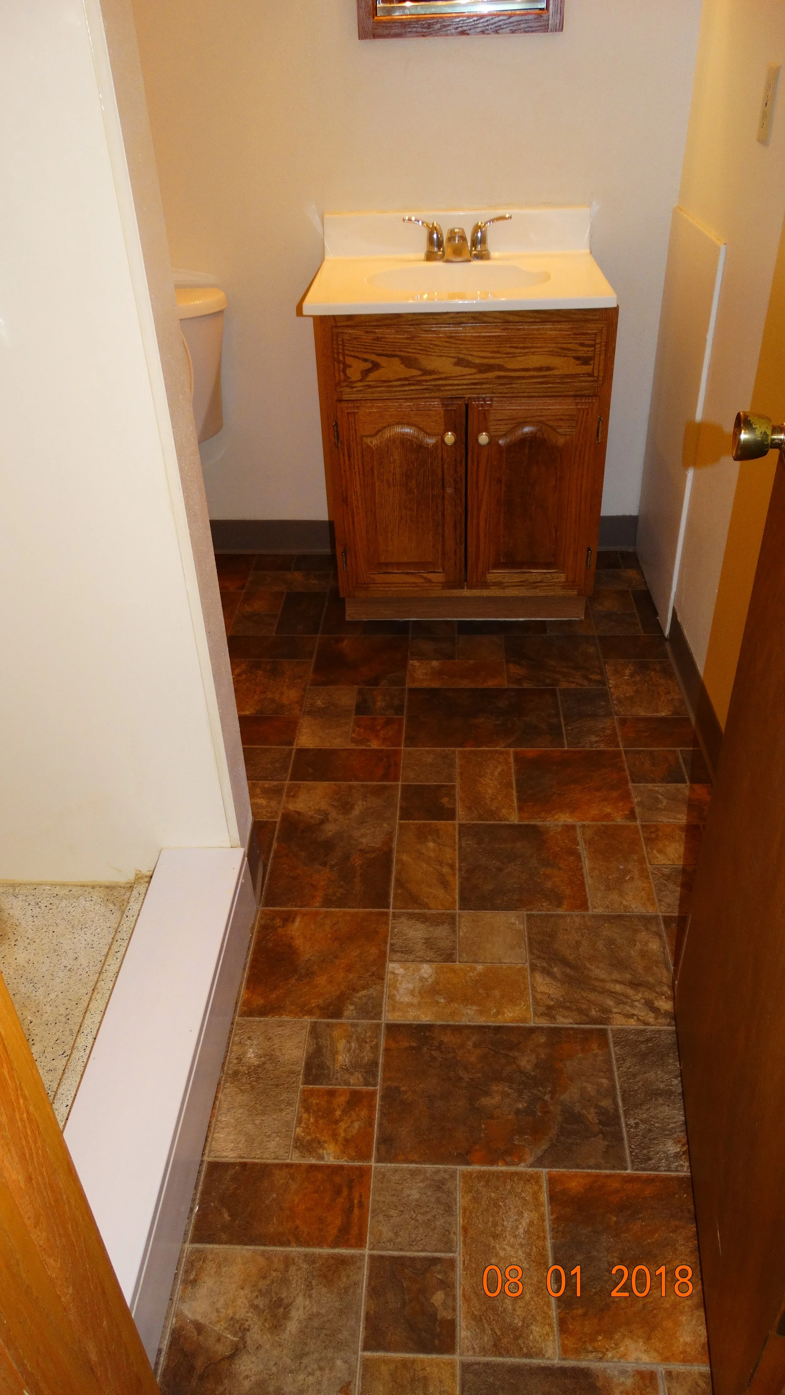 Tile bathroom floor 2-bedroom apartment at Hartwell Place Apartments in Waukesha