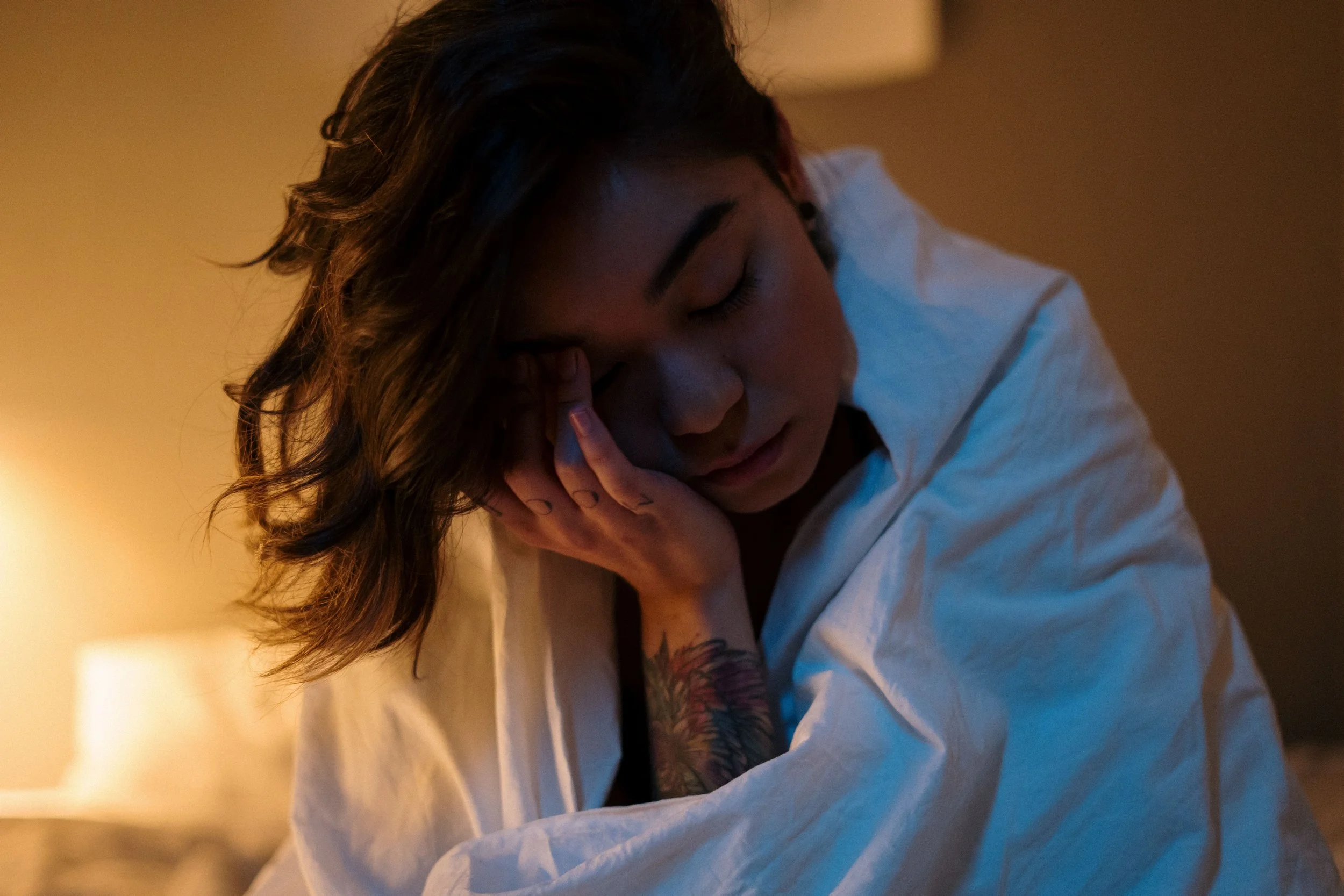 Tired woman wrapped in a blanket