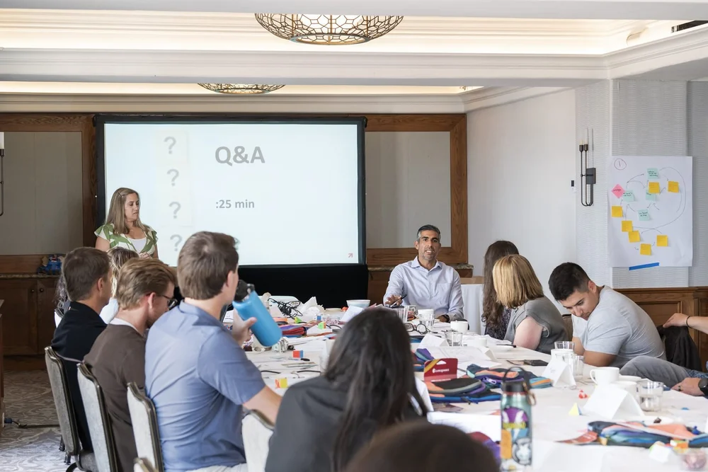 An Excelerate working session with a Q&A slide on the screen.