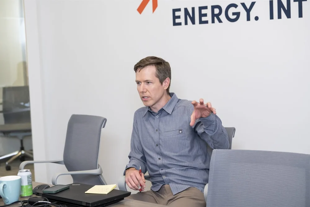An Excelerate consultant explaining a point during a meeting.