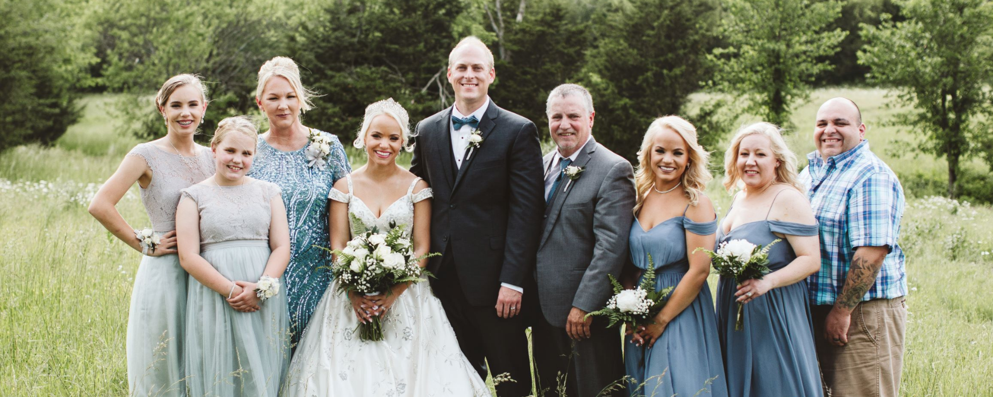 Wedding couple celebrating with family at Troyer’s Prairie Gold in Garnett, Kansas