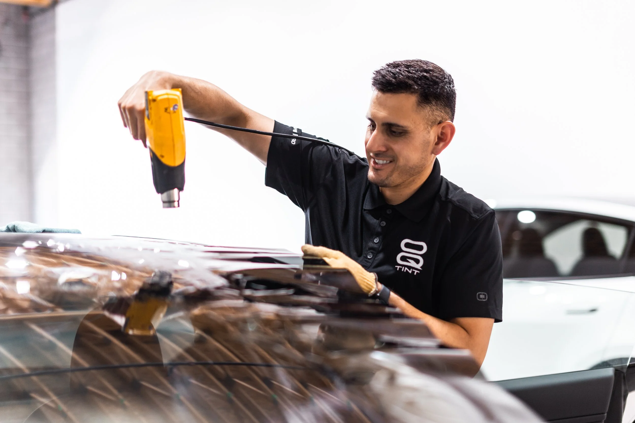 Window tint shrinking with heat gun on Tesla model 3 back window.