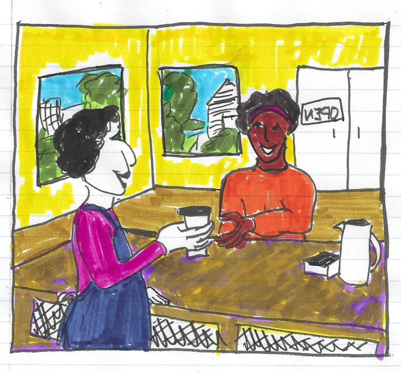 A young woman with curly hair smiling, wearing glasses, hoop earrings, and layered necklaces, in a bright indoor setting.