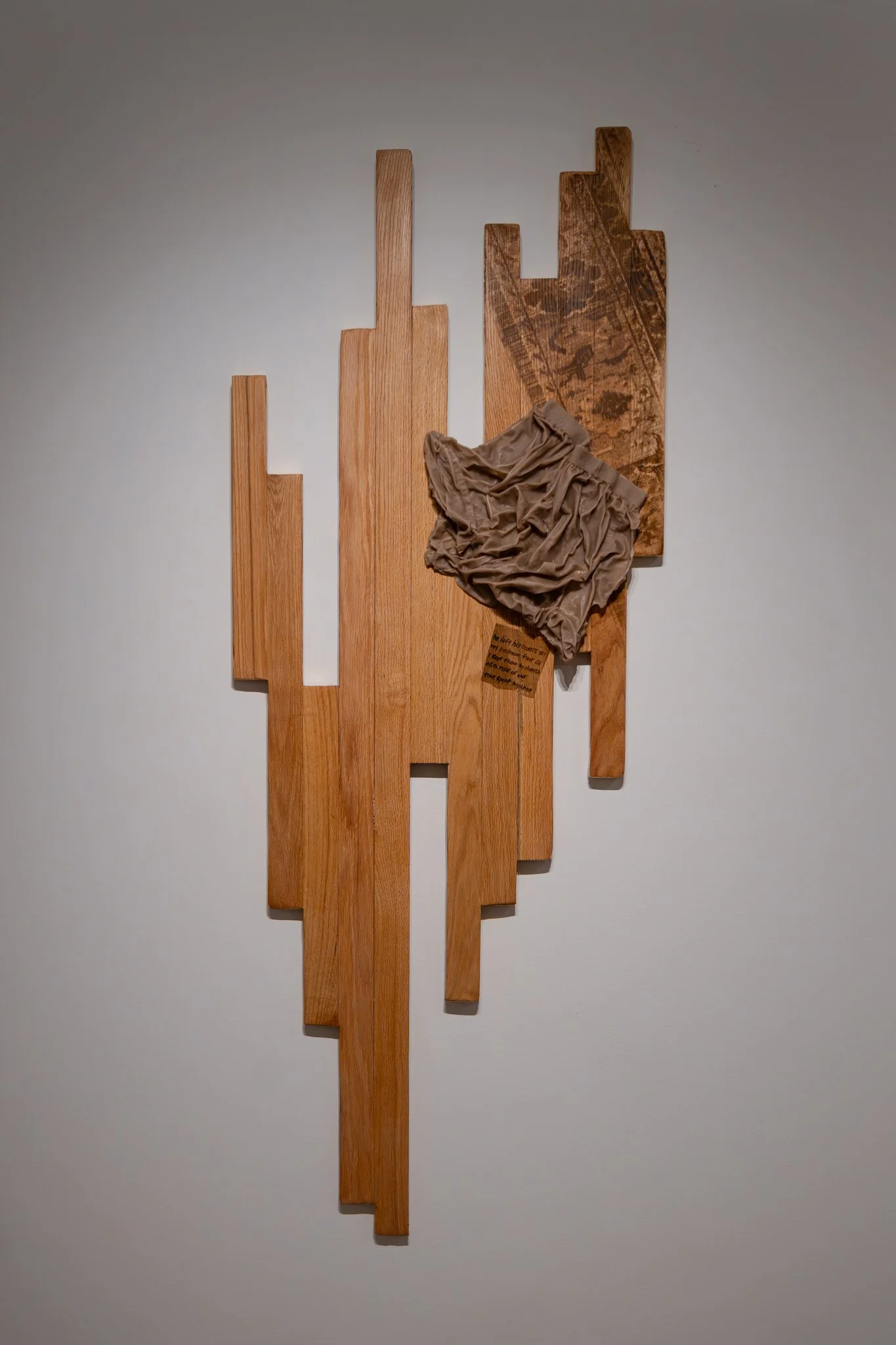 𝘤𝘰𝘭𝘦 – 𝘮𝘢𝘳𝘤𝘩 21, 2025. 2026. red oak hardwood, screen printed wood stain, metal leaf, cast wax. 69"H x 27"W.
