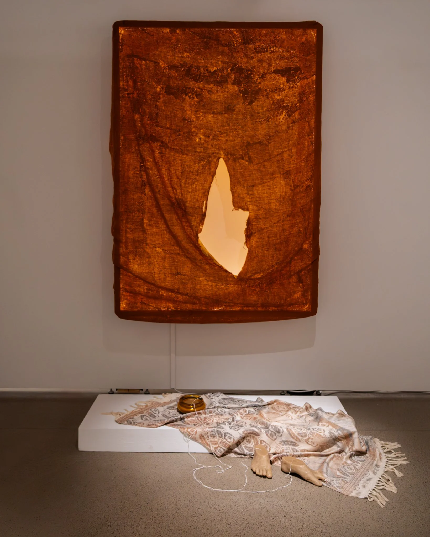 𝘳𝘦𝘭𝘪𝘤𝘴 𝘰𝘧 𝘪𝘯𝘵𝘪𝘮𝘢𝘤𝘺. 2026. installation view | 𝘳𝘦𝘭𝘪𝘤 𝘯𝘰.1: linen bed sheets worn from september 7, 2023 to february 2, 2025; metal leaf, LEDs. 72”h x 54”w x 10”d |
𝘳𝘦𝘭𝘪𝘤 𝘯𝘰.2:  cotton, polyester, and nylon handwoven on TC