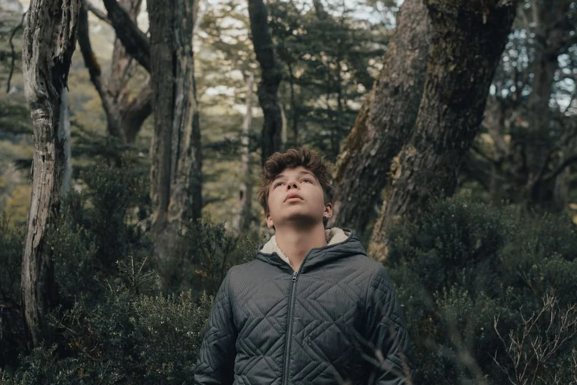 teenager-wearing-jacket-in-forest