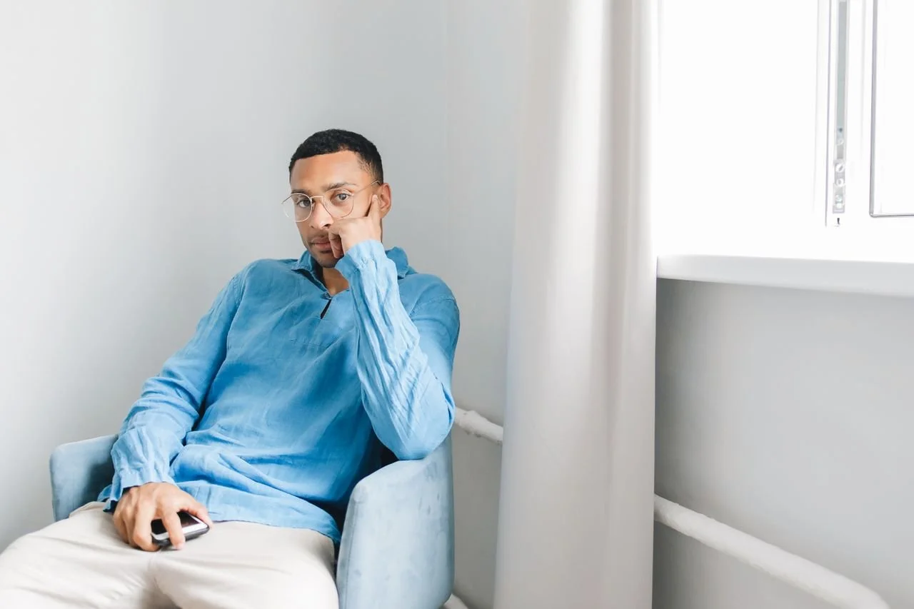man-in-blue-long-sleeves-sitting-on-the-chair