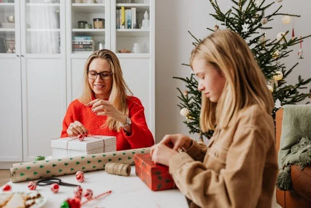 woman-and-a-girl-wrapping-gifts