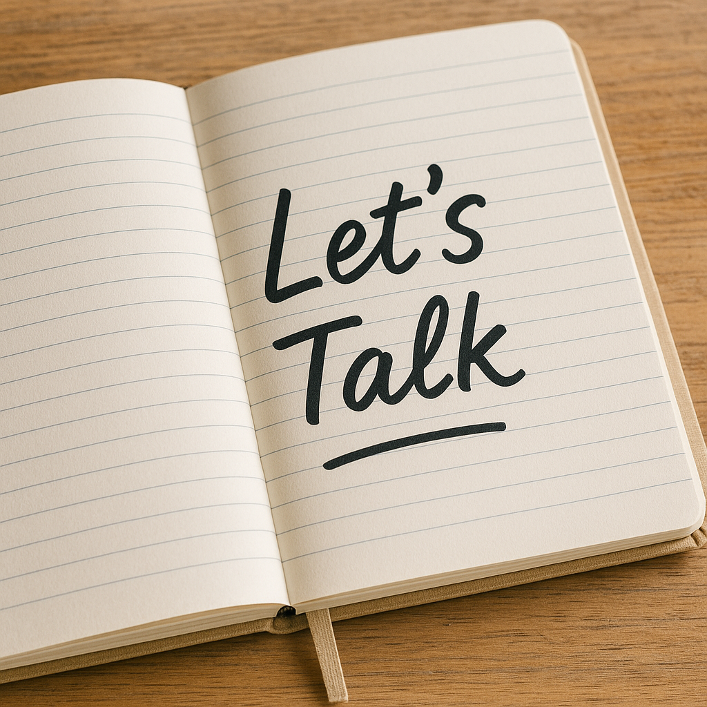 A handwritten note in an open planner reads “Let’s Talk,” resting on a tidy desk with soft lighting—inviting and approachable.