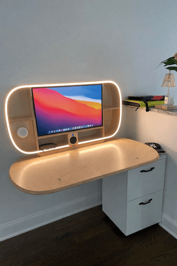 A murphy desk with MagSafe charger and built in monitor