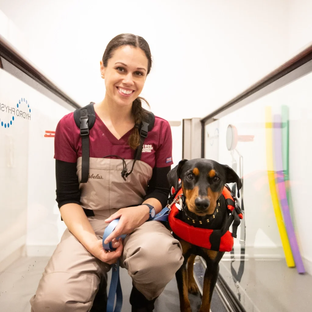 Pearl, the owner and director of The Dog Wellness Centre with her dog Tonka in a canine hydrotherapy bath
