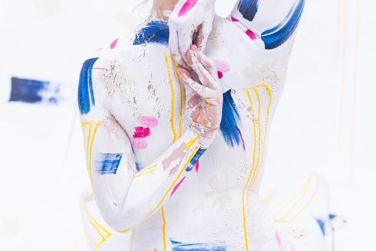 Woman covered in paint and connecting her hands behind her back