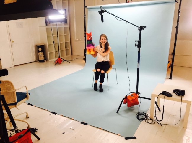 Sarah Dubow, health coach and wellness expert, holding up a piñata on set with LOLA