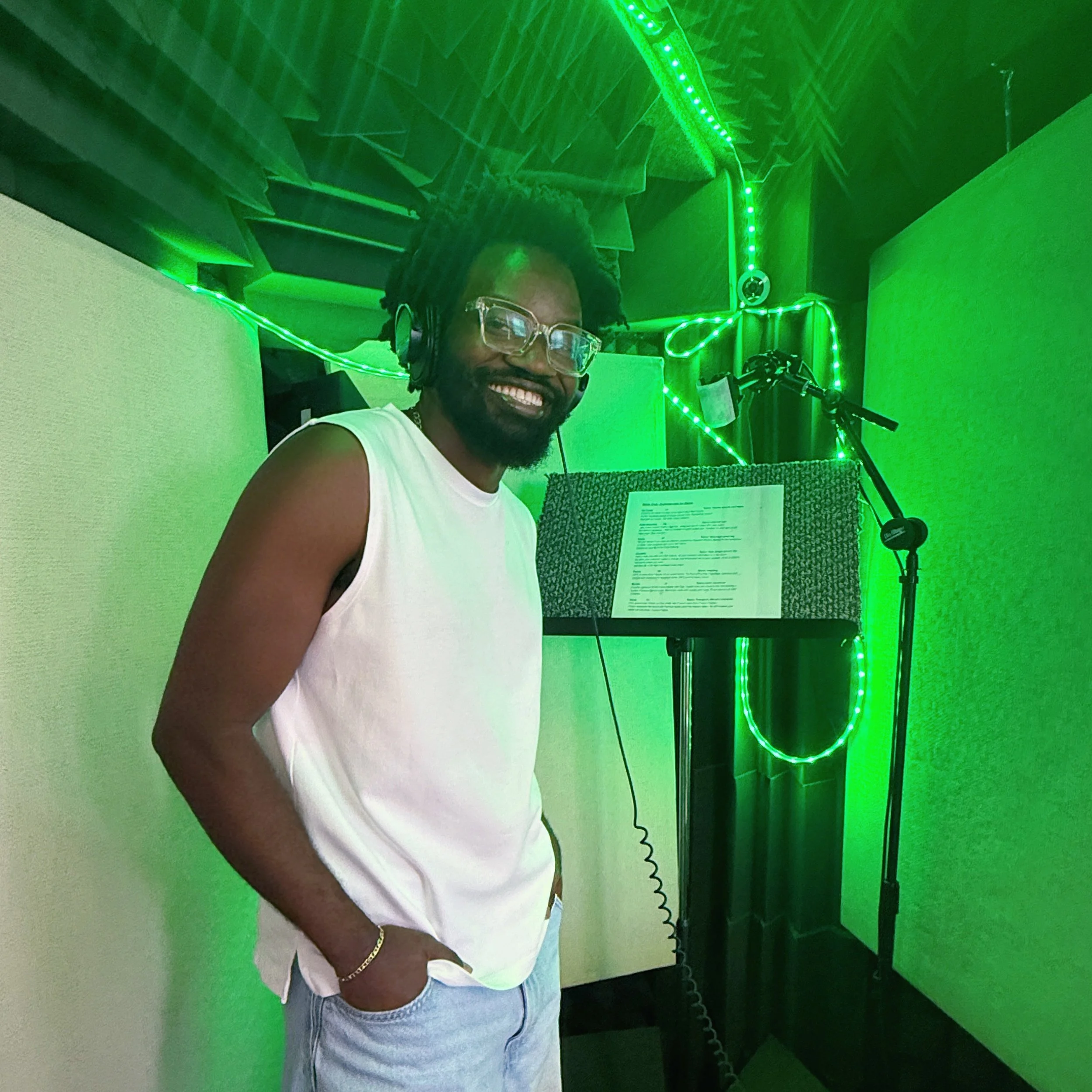 Candid photo of Black male voice actor Wildy Civil in a professional voiceover booth.