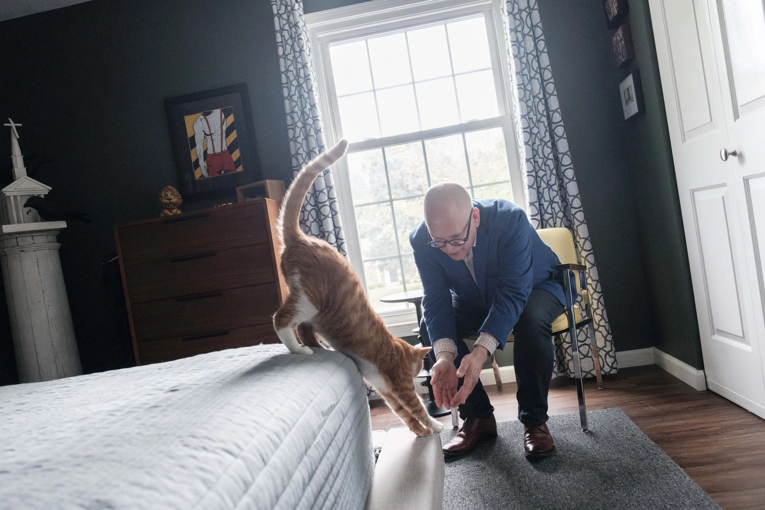 Obergefell plays with his cat, Oliver, at his home in Sandusky.